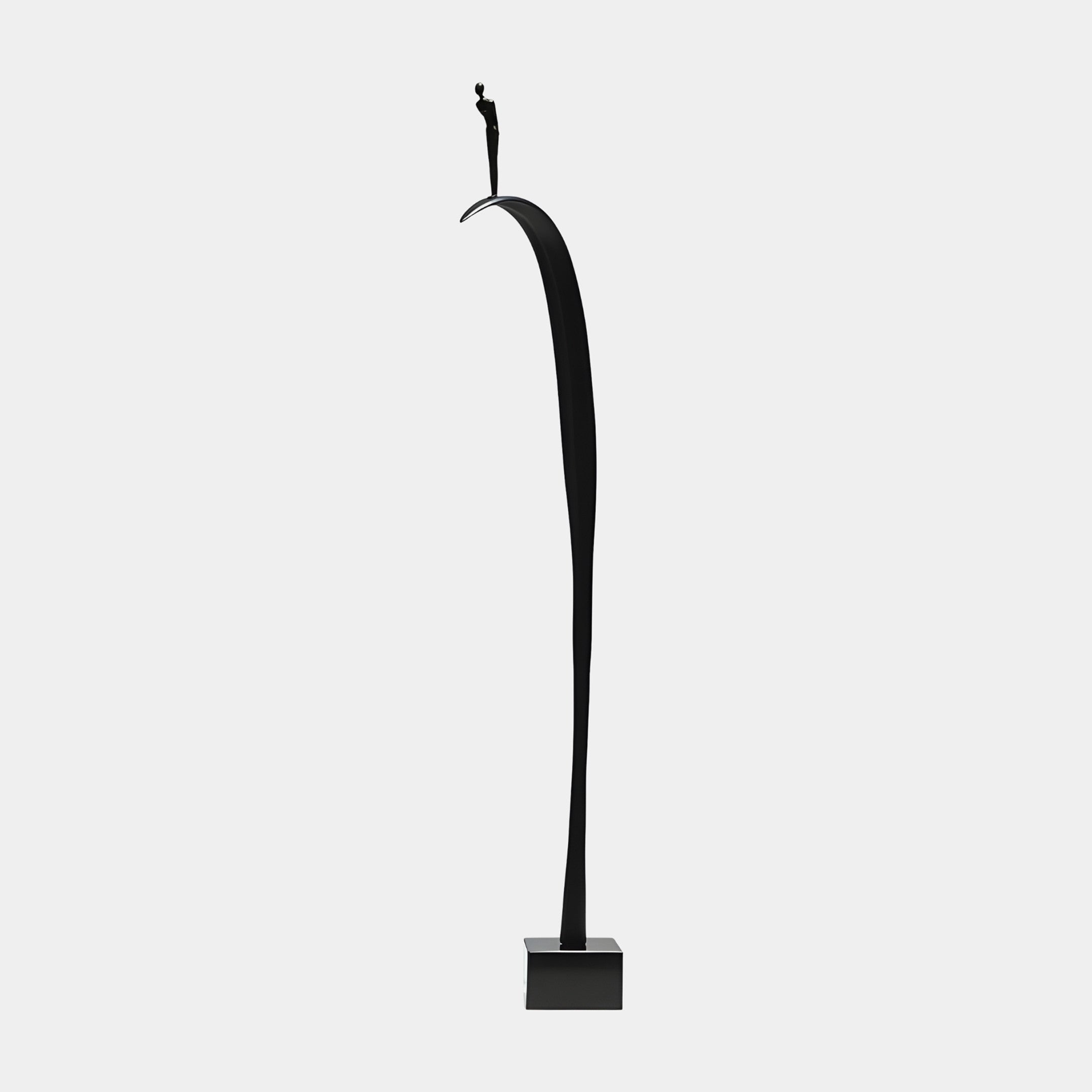 Black Abstract Tall Arc with Standing Figure Sculpture by Giant Sculptures, a slender curving form in matte black resin topped with a small figure on a cube base.