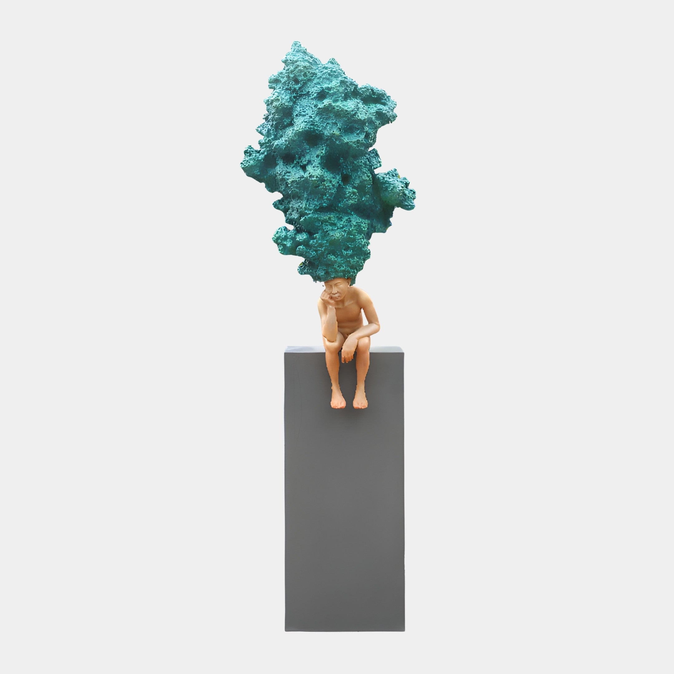 Giant Sculptures Teal Abstract Tree Form Sculpture showing a seated nude figure with a textured teal coral-like canopy for a head, on a tall grey plinth.