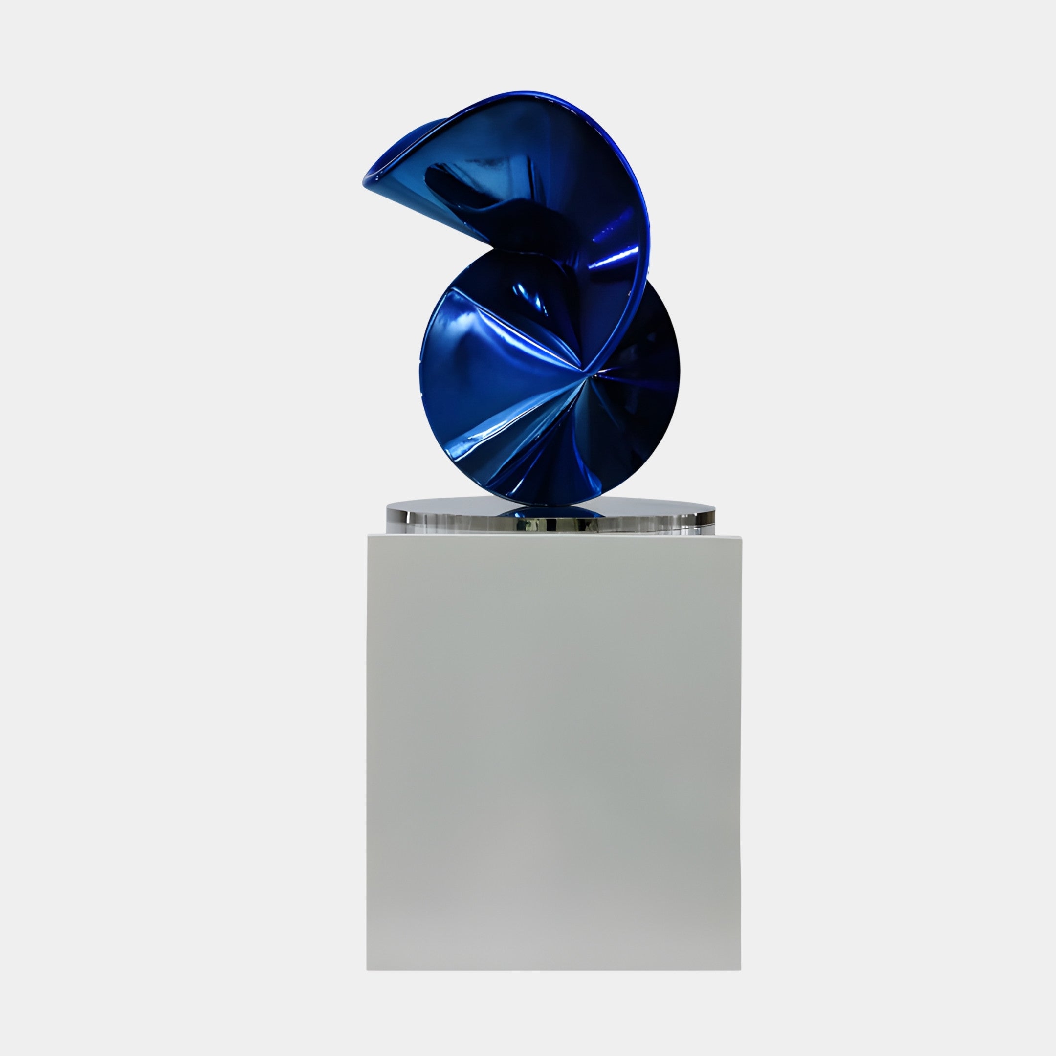 Giant Sculptures Blue Abstract Flowing Knot Sculpture in glossy metallic blue 3D-printed resin, displayed on a tall white pedestal against a light background.
