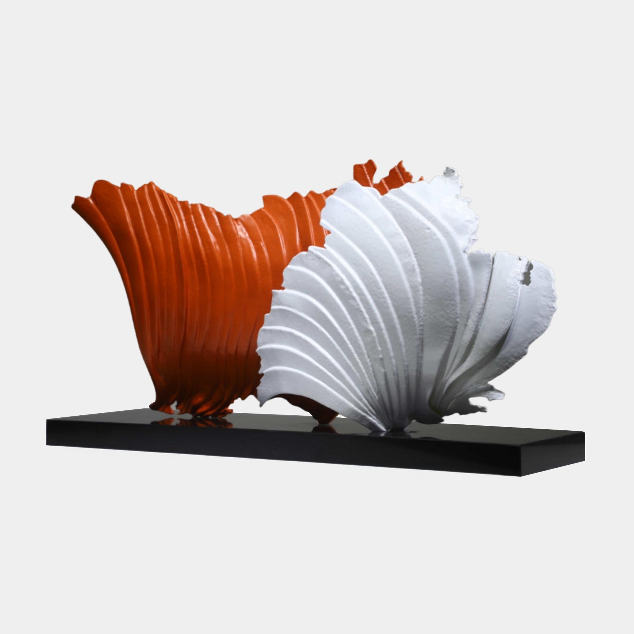 Giant Sculptures Orange and White Abstract Fan Bloom Sculpture, two ribbed fan-shaped blooms in orange and white on a sleek black base, plain background.
