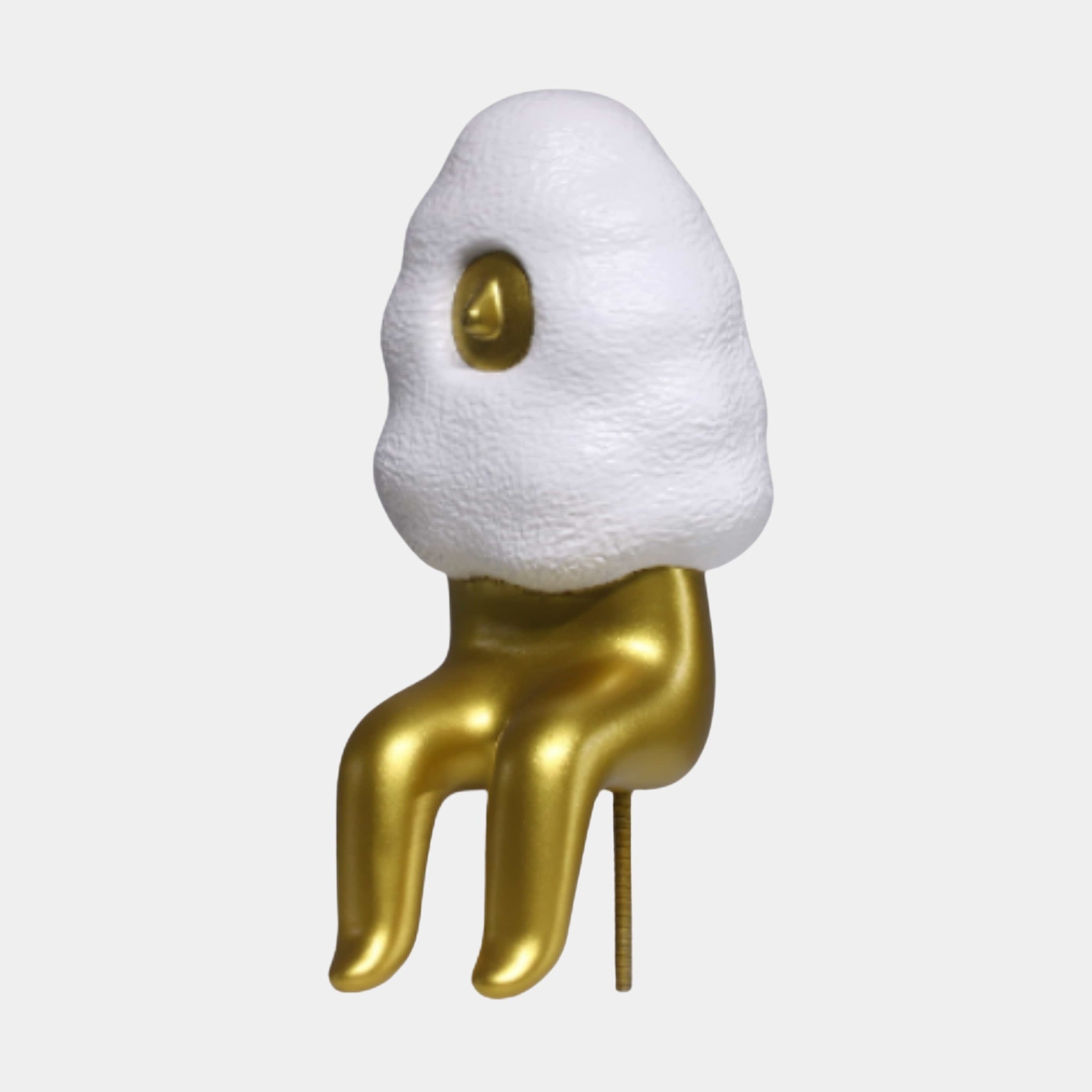 Giant Sculptures Gold Abstract Character Sitting on Egg Sculpture 24cm with a textured white egg-shaped body and glossy gold dangling legs on a plain background.