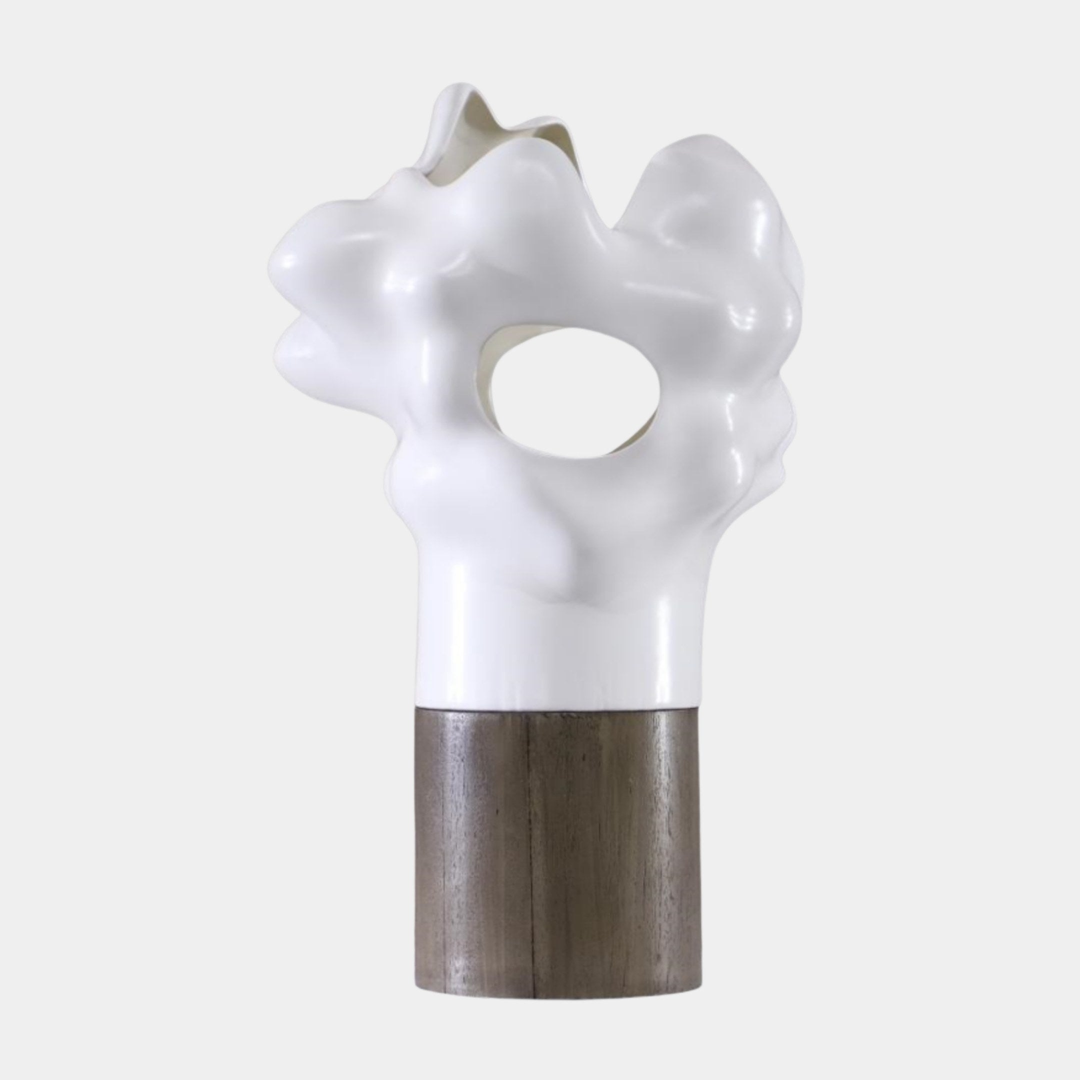 Glossy white abstract organic blob sculpture by Giant Sculptures with bulbous curves and a central opening, set on a natural wood cylinder base.