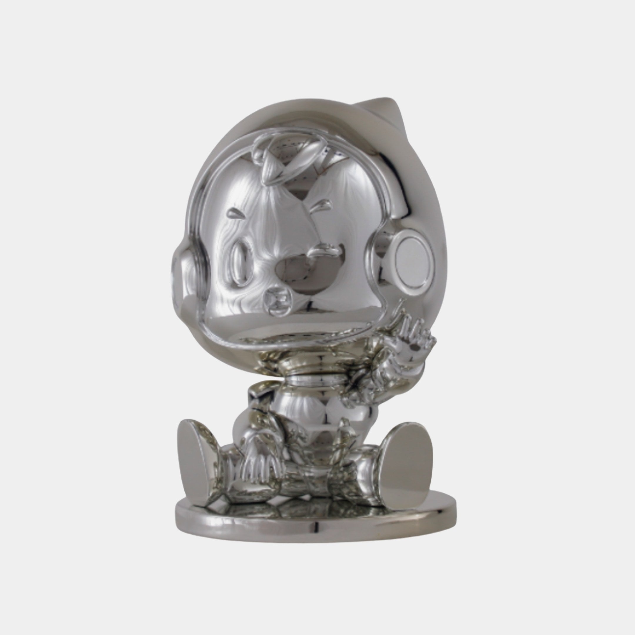 Silver Chrome Astronaut Character Sculpture by Giant Sculptures, a seated chibi-style figure with oversized helmet and mirror-chrome finish on a round base.