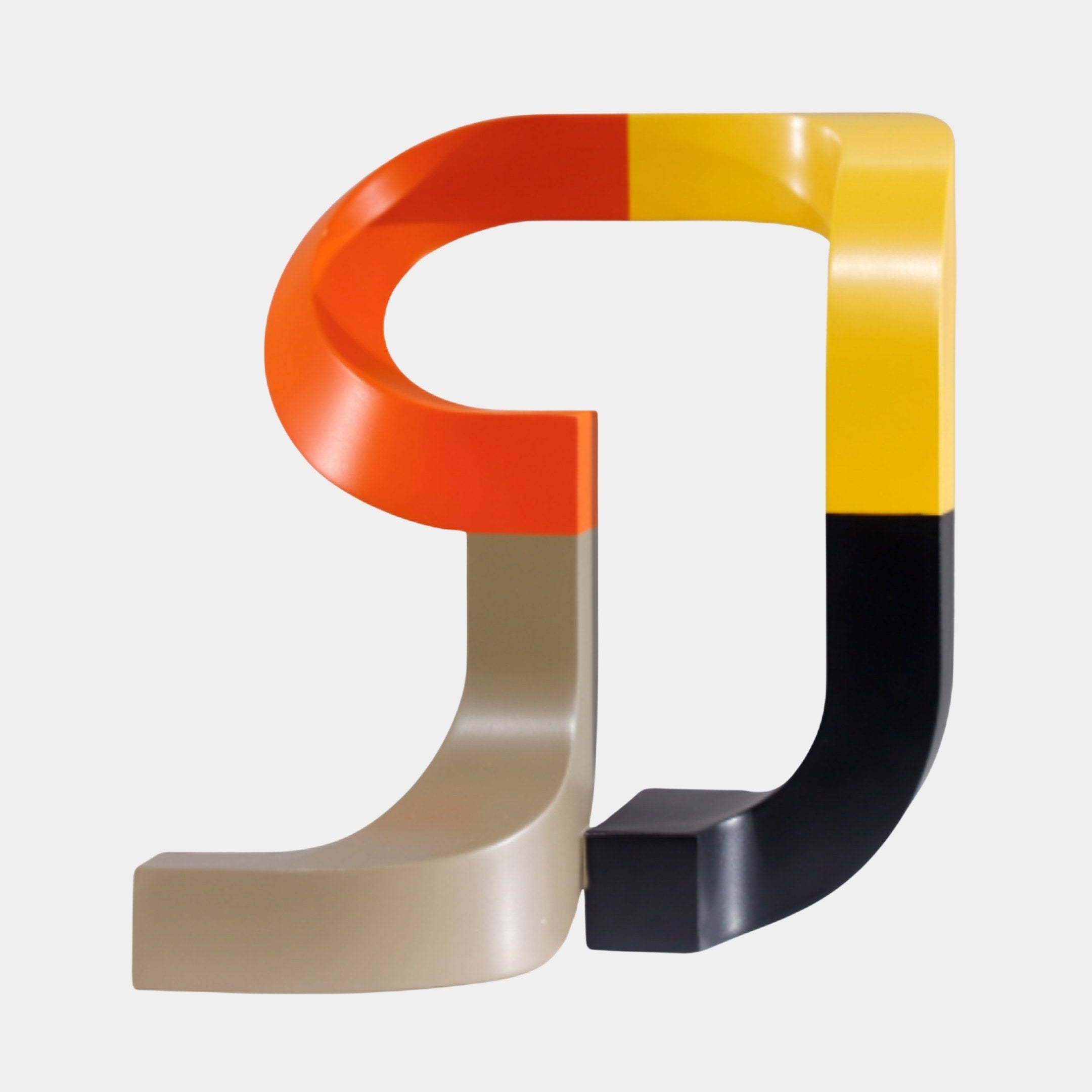 Multi-Colour Abstract Letter J Sculpture by Giant Sculptures, 21cm, two interlocking glossy resin J forms in orange, yellow, beige, and black on a white background.