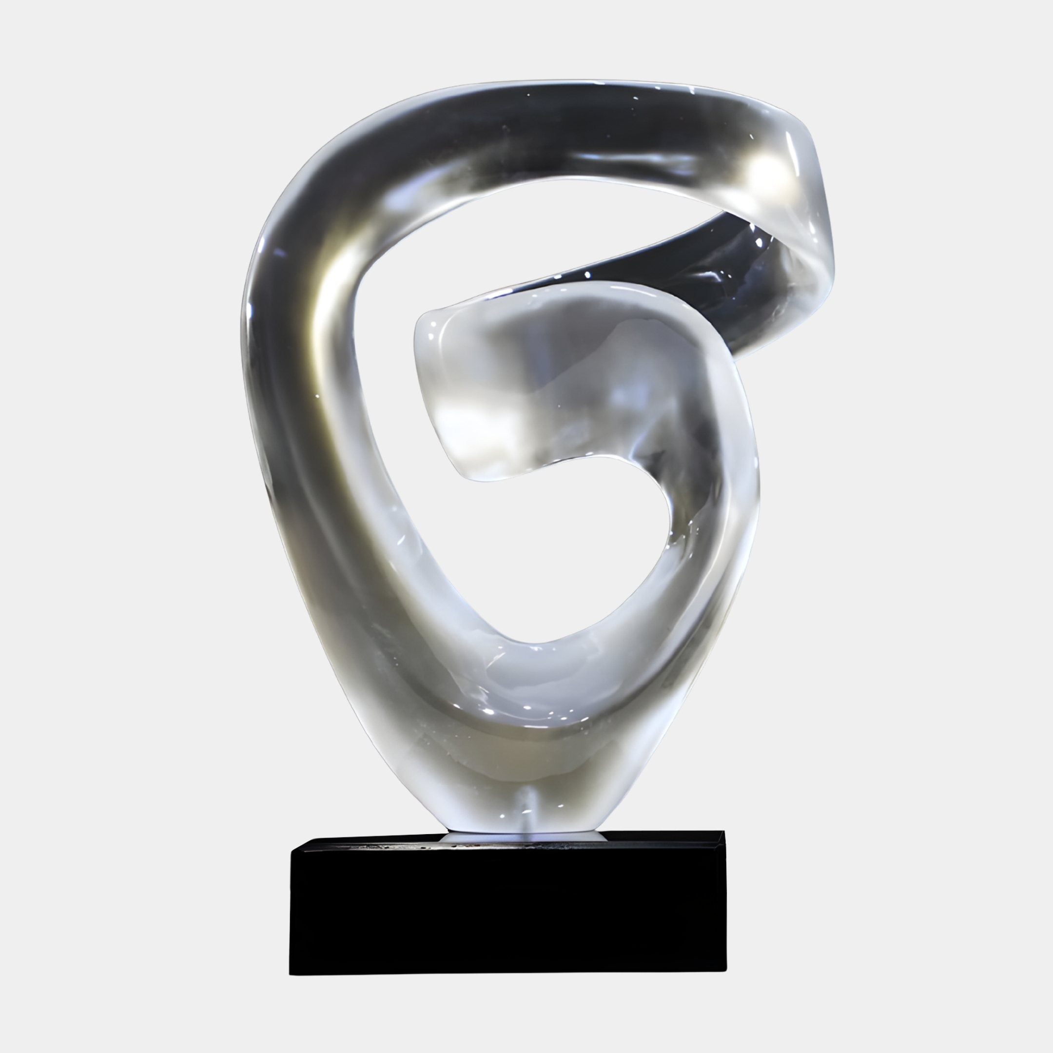 Eternal Swirl Smoke Grey Abstract Jade Sculpture by Giant Sculptures, a swirling ribbon form in smoky silver-grey on a black plinth against a light background.