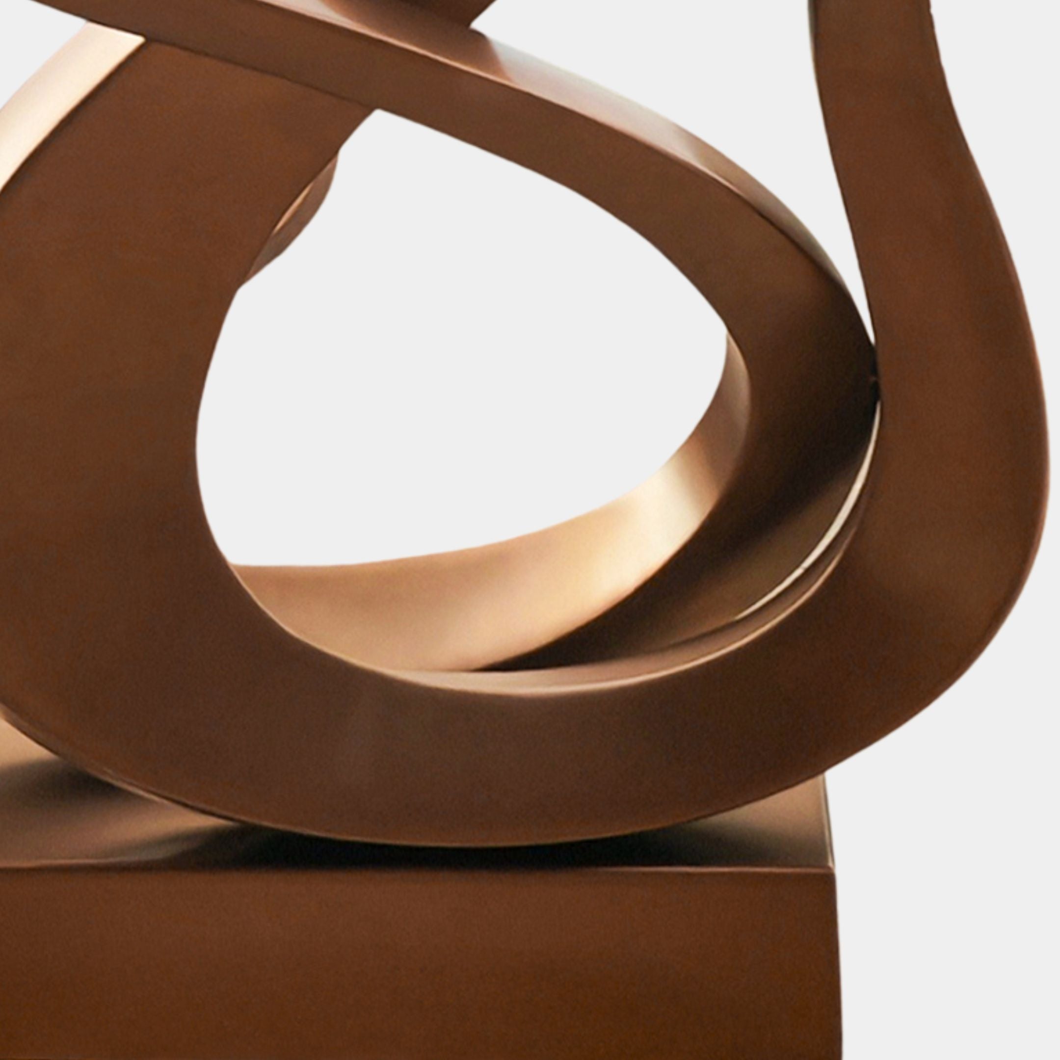Close-up of Giant Sculptures' Flame III Matt Bronze Abstract Steel Sculpture (130cm): a contemporary artwork with smooth, intertwining curves and loops on a rectangular base, set against a plain white background.