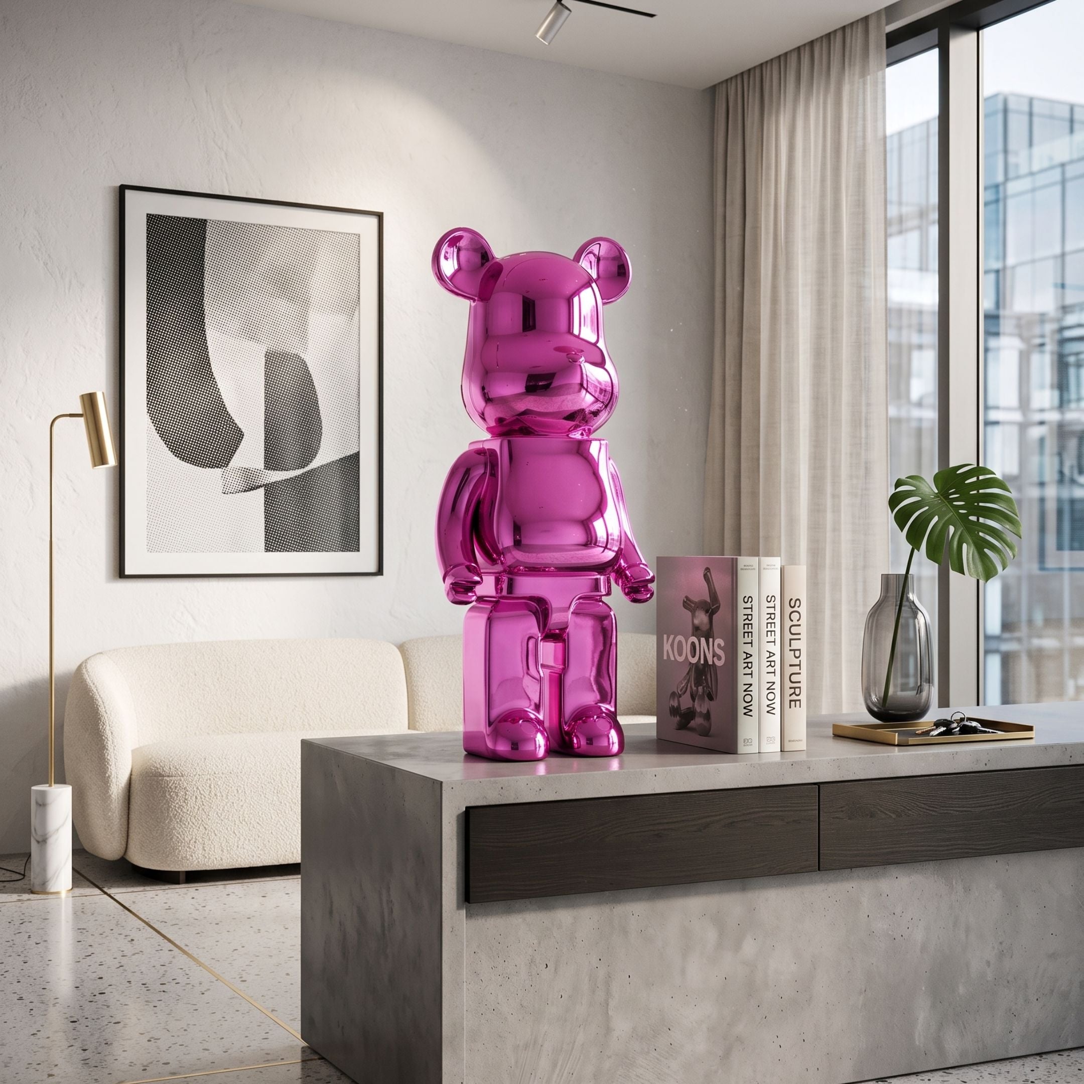 Flamingo Pink Bear Sculpture, 50cm, glossy metallic pink finish, displayed on a sideboard beside books and a vase in a modern living room.