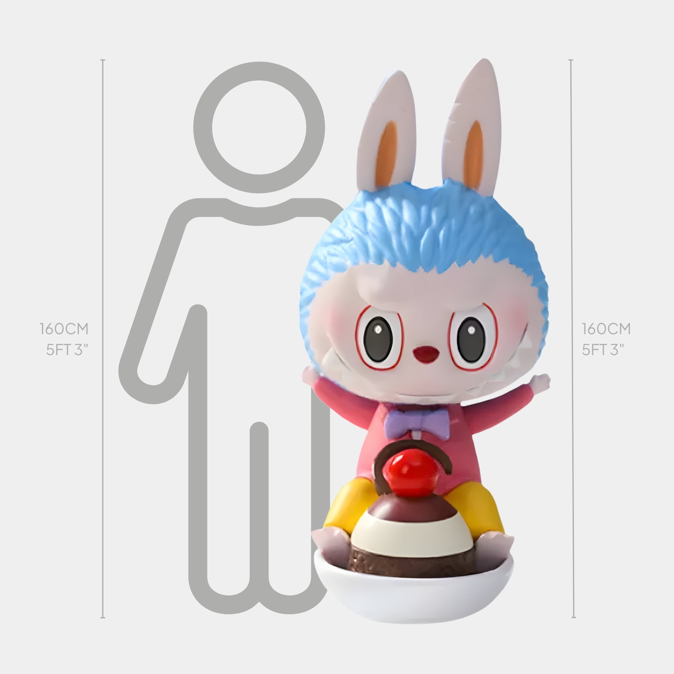 The Sweet Mischief Cherry Ride Labubu Sculpture by Giant Sculptures is a 160cm (5ft 3in) tall fibreglass piece featuring a large blue cartoon rabbit with big ears and wide eyes sitting on a red and brown dessert-themed spoon base.