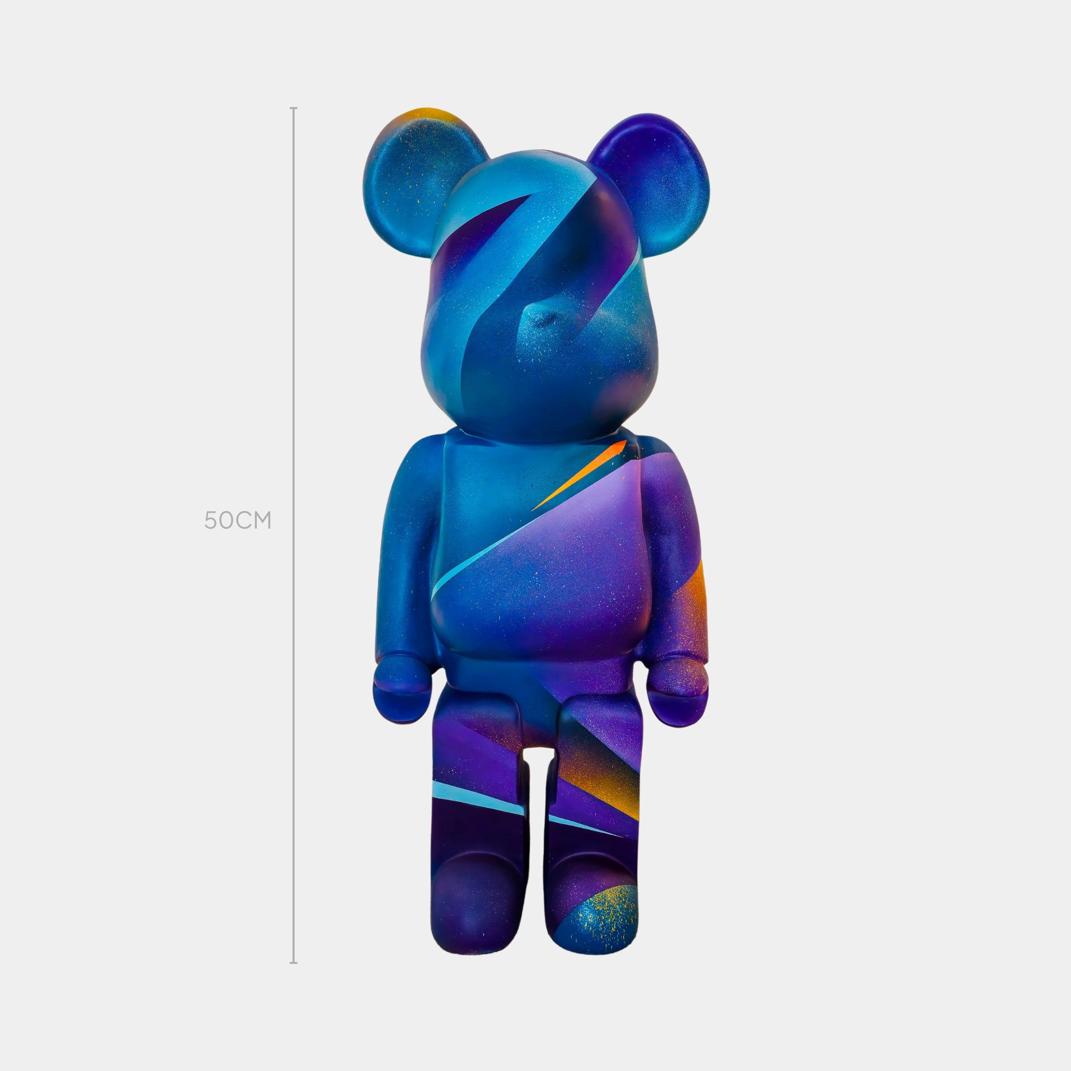 The Giant Sculptures Midnight Sunset Bear Sculpture - 50cm features a smooth, abstract design in blue, purple, and orange—an eye-catching piece of contemporary art standing upright against a plain light background.