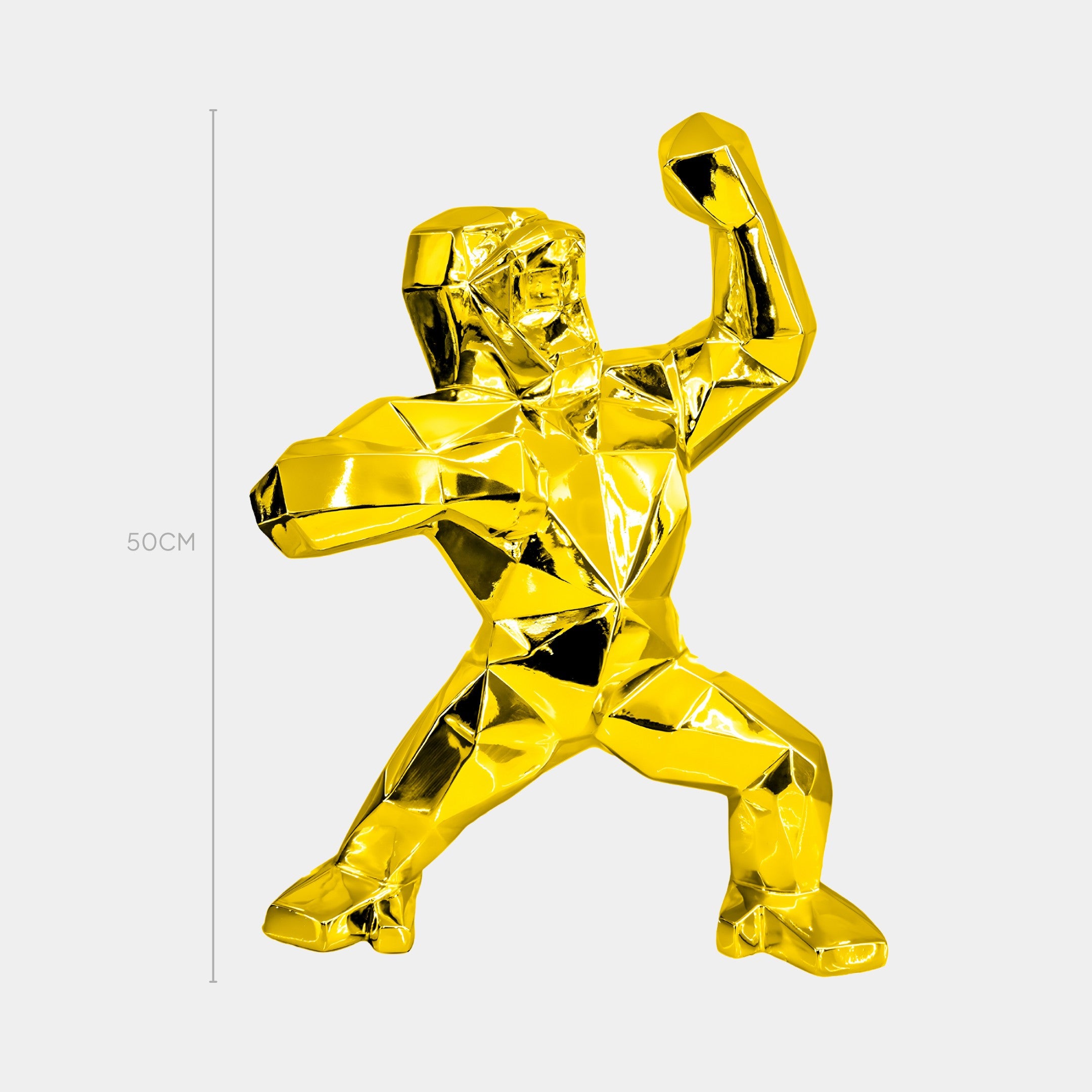 The Gilded Gold Gorilla Sculpture by Giant Sculptures is a luxury interior decor piece featuring geometric, faceted surfaces. This 50cm tall artwork showcases a gorilla in a powerful pose, set against a plain white background.