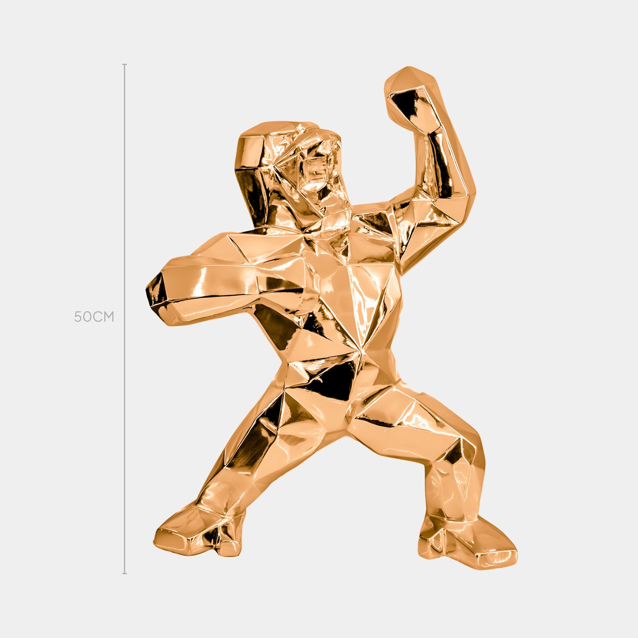 The Rose Gold Gorilla Sculpture by Giant Sculptures stands 50 cm tall, featuring geometric facets and a powerful pose with one arm raised, making it a striking modern centerpiece that adds an artistic flair to any plain background.