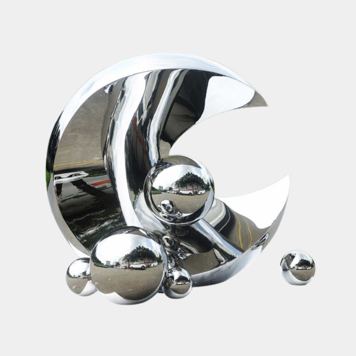 Silver Crescent Moon with Spheres Sculpture, 250cm, mirror-polished stainless steel with clustered spheres at its base, on a plain light grey background.