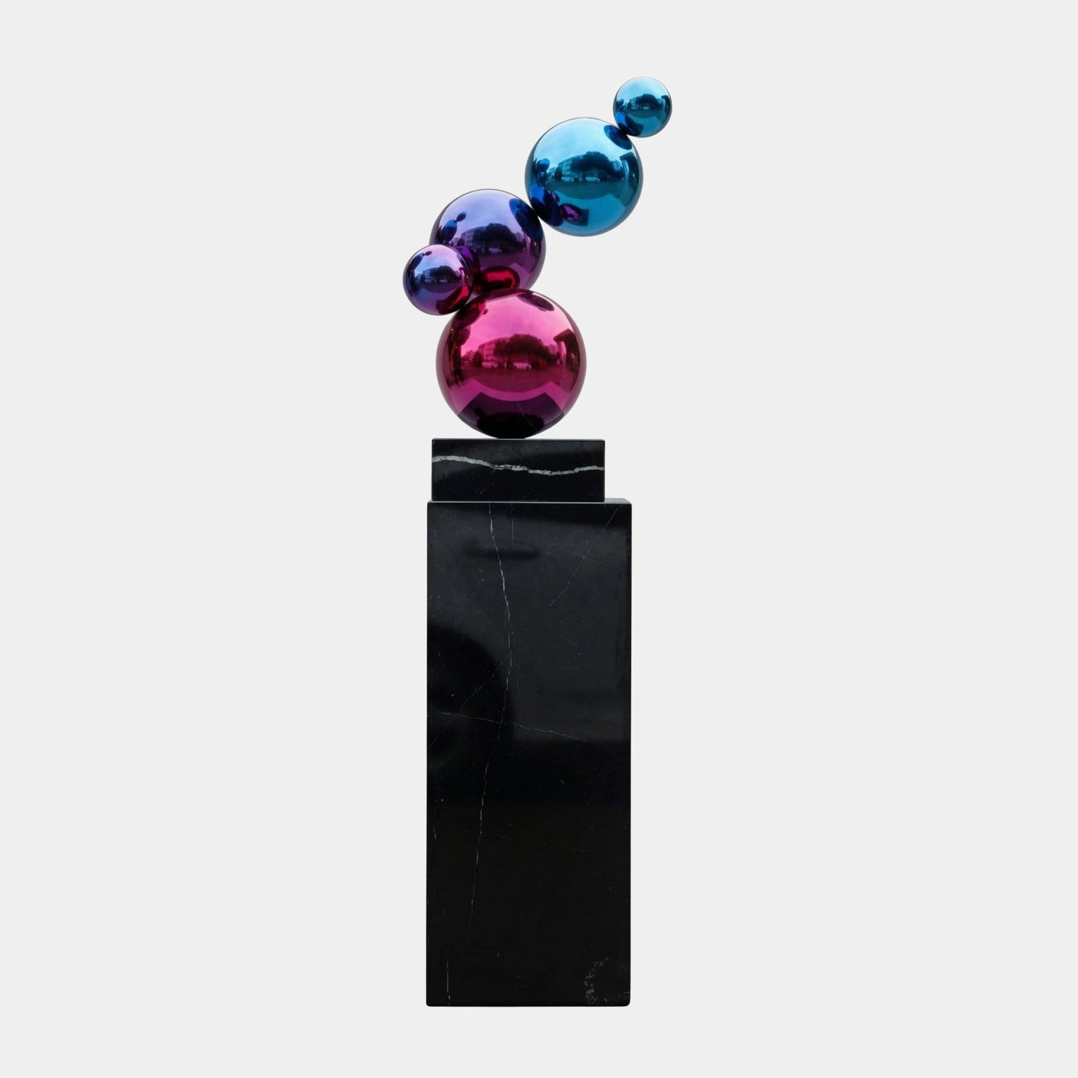 Multi-Colour Sphere Cluster on Black Base Stainless Steel Sculpture with pink, purple, and blue spheres on a black marble base, shown against a plain white background.