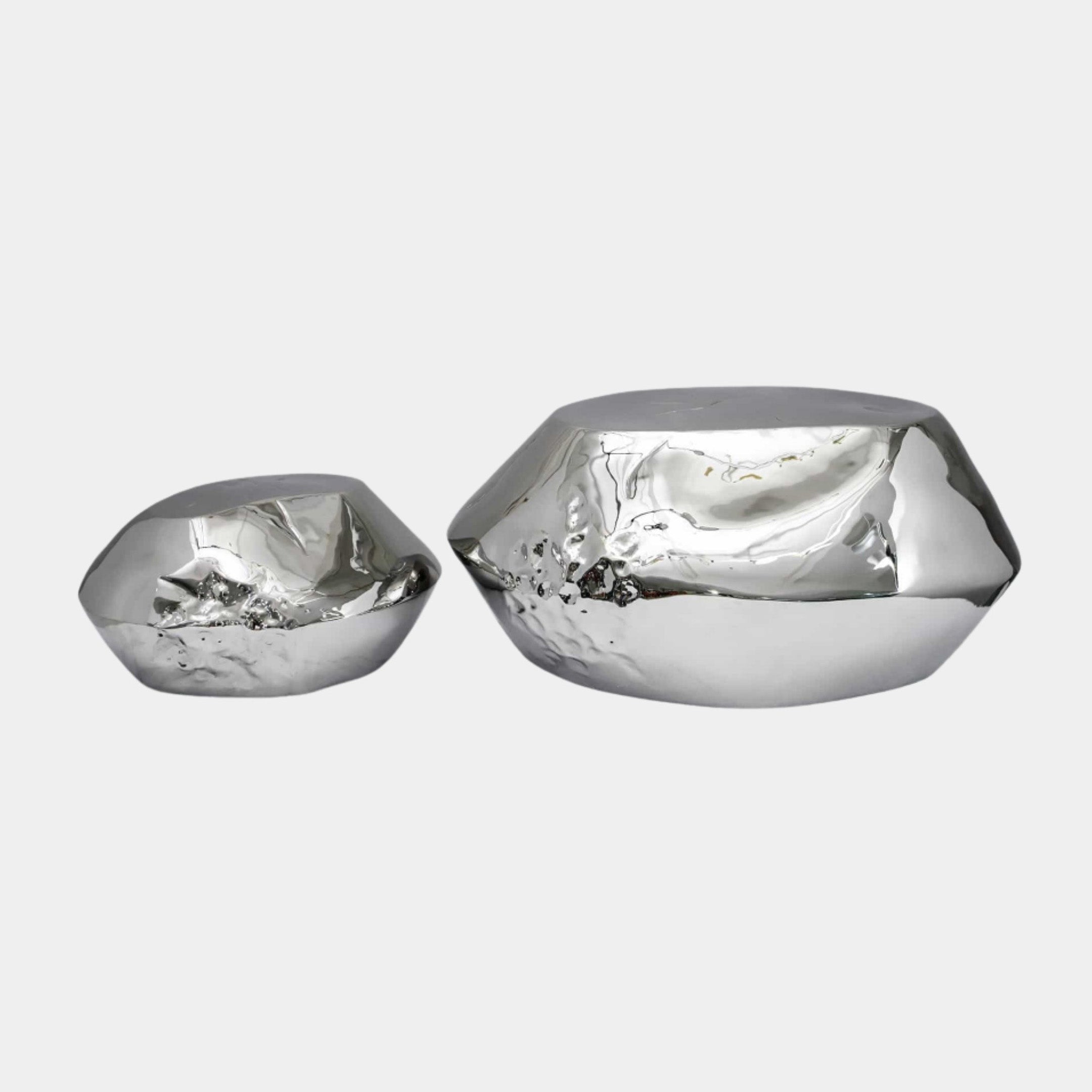 Silver Boulders with Hollowed Tops (45/68cm) by Giant Sculptures, two polished stainless steel faceted forms with hollowed tops, shown in varying sizes on a plain white background.