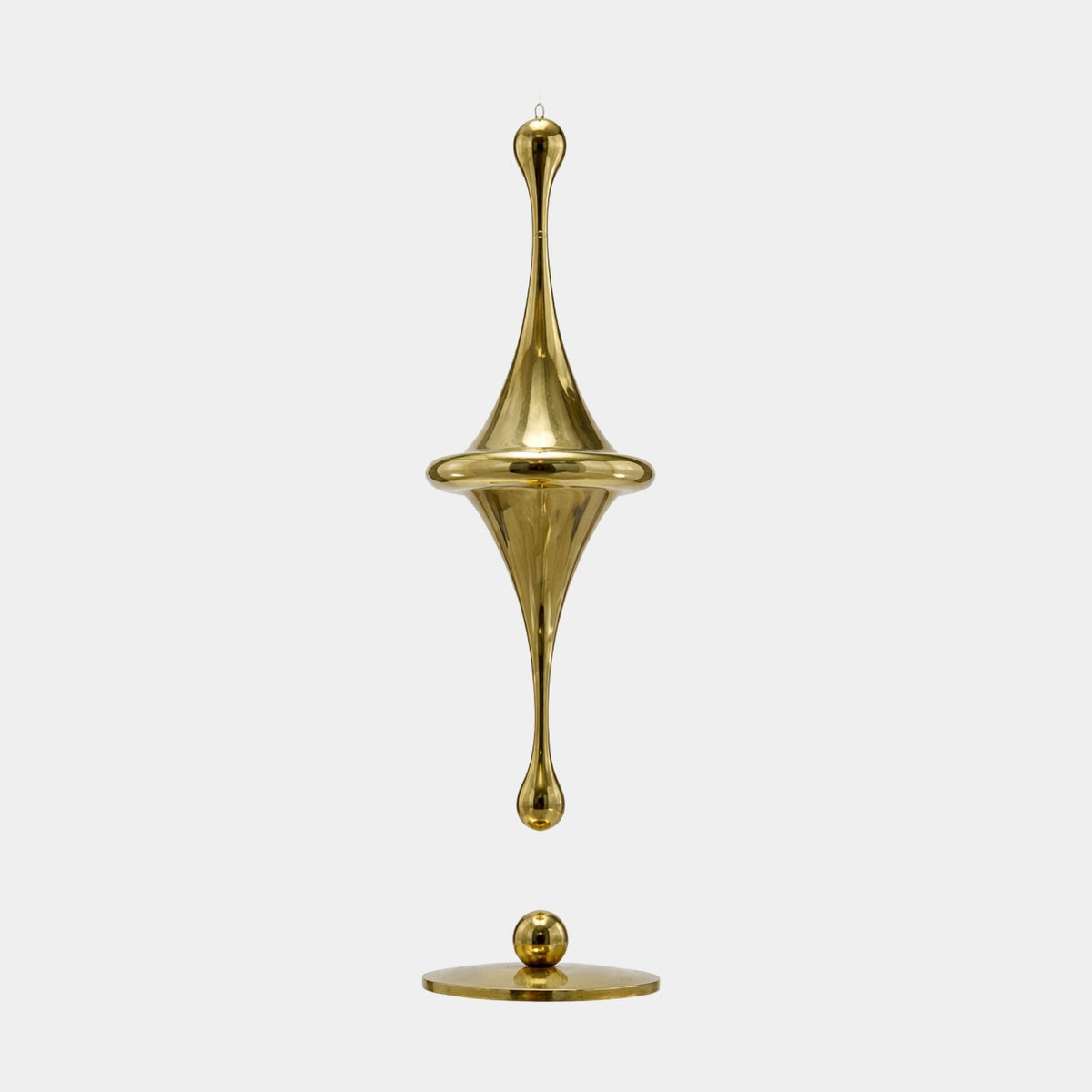 Gold Spinning Top Form Stainless Steel Sculpture, 130cm, shown suspended above a matching round base on a plain light grey background.