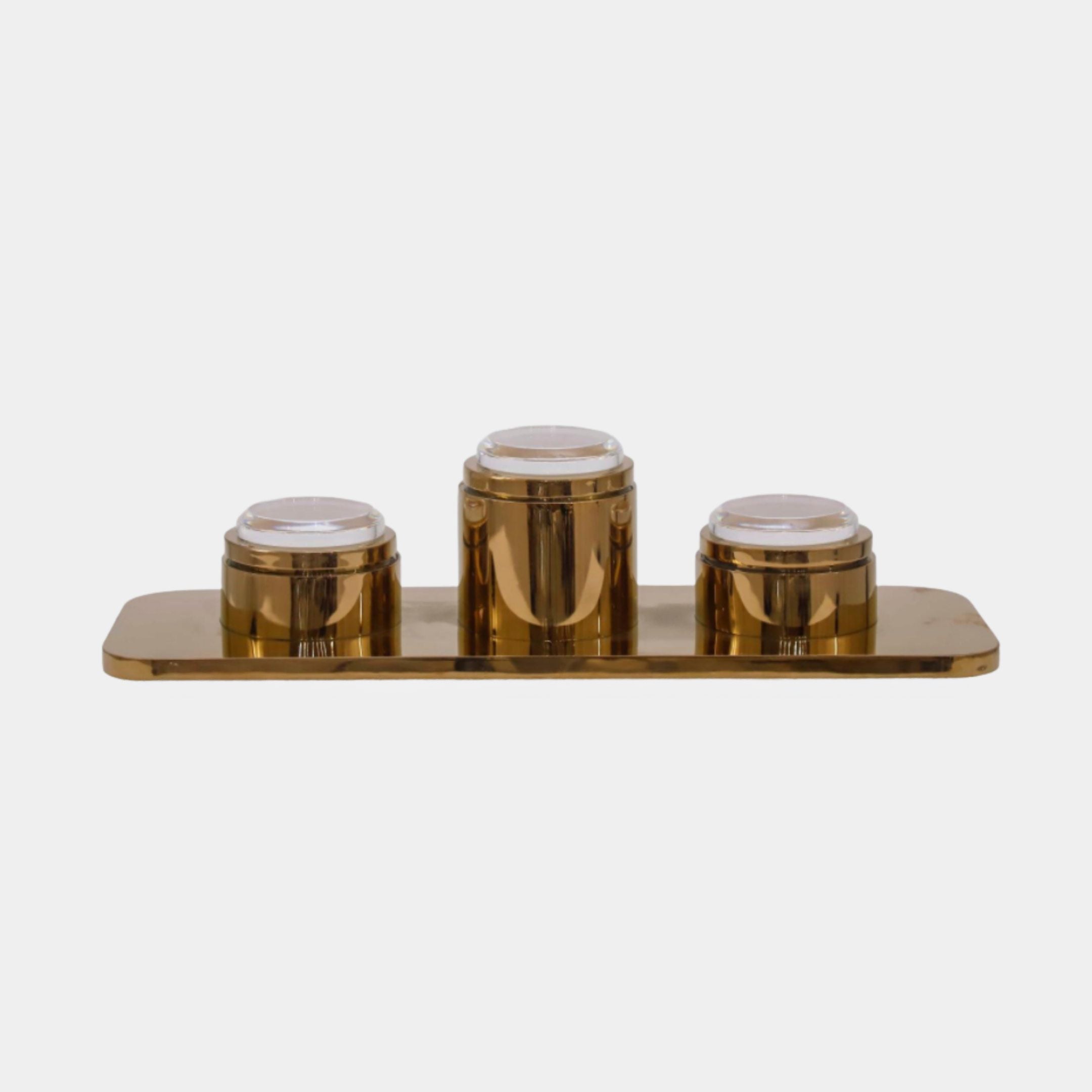 Gold Canister Set on Tray, Giant Sculptures, stainless steel with three round lidded canisters on a rectangular tray, plain white background, 15cm size.