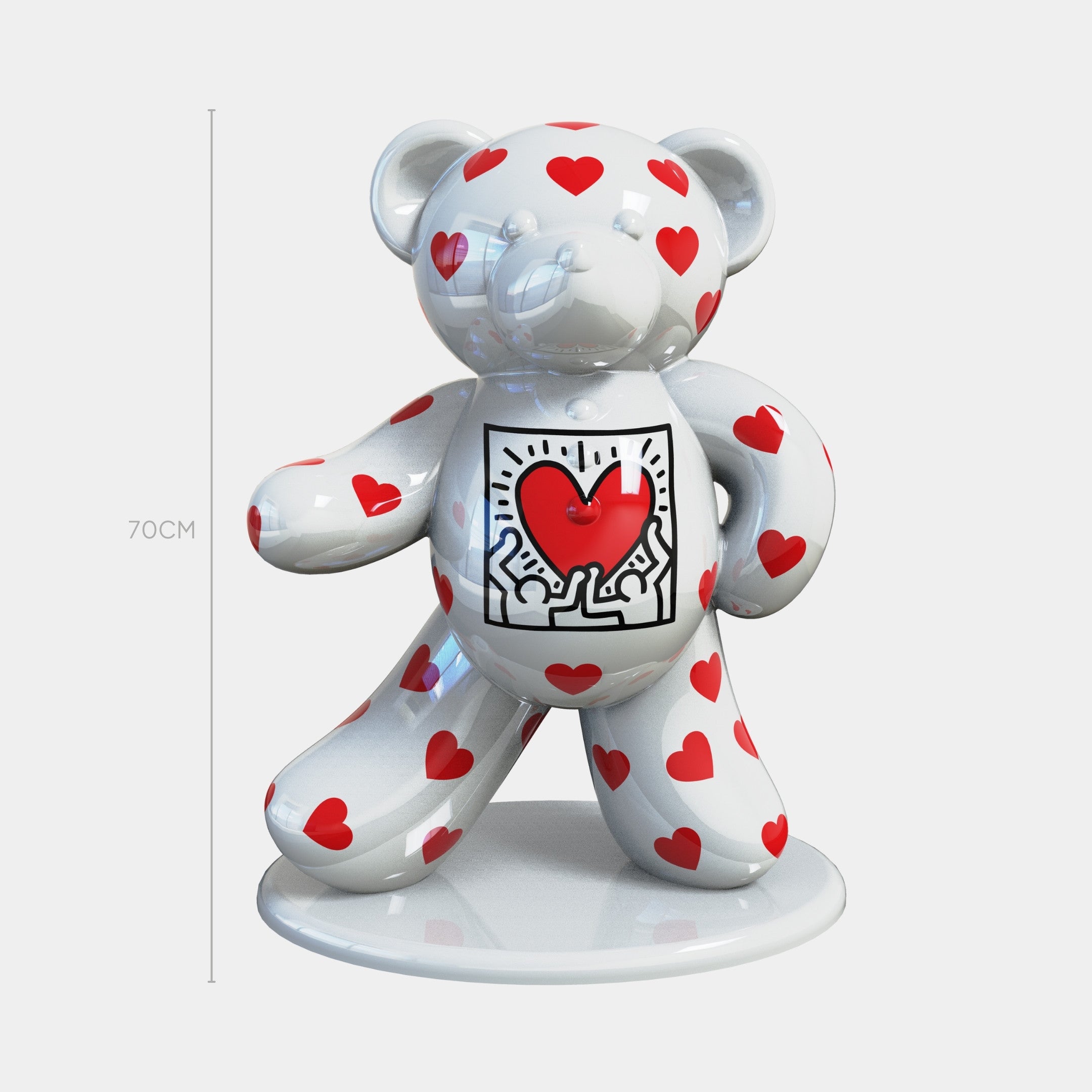 The Gacko Keith Haring White Bear Sculpture by Giant Sculptures stands 70cm tall, features a glossy white finish with red hearts and two figures holding a red heart on its belly, and is displayed on a round base.