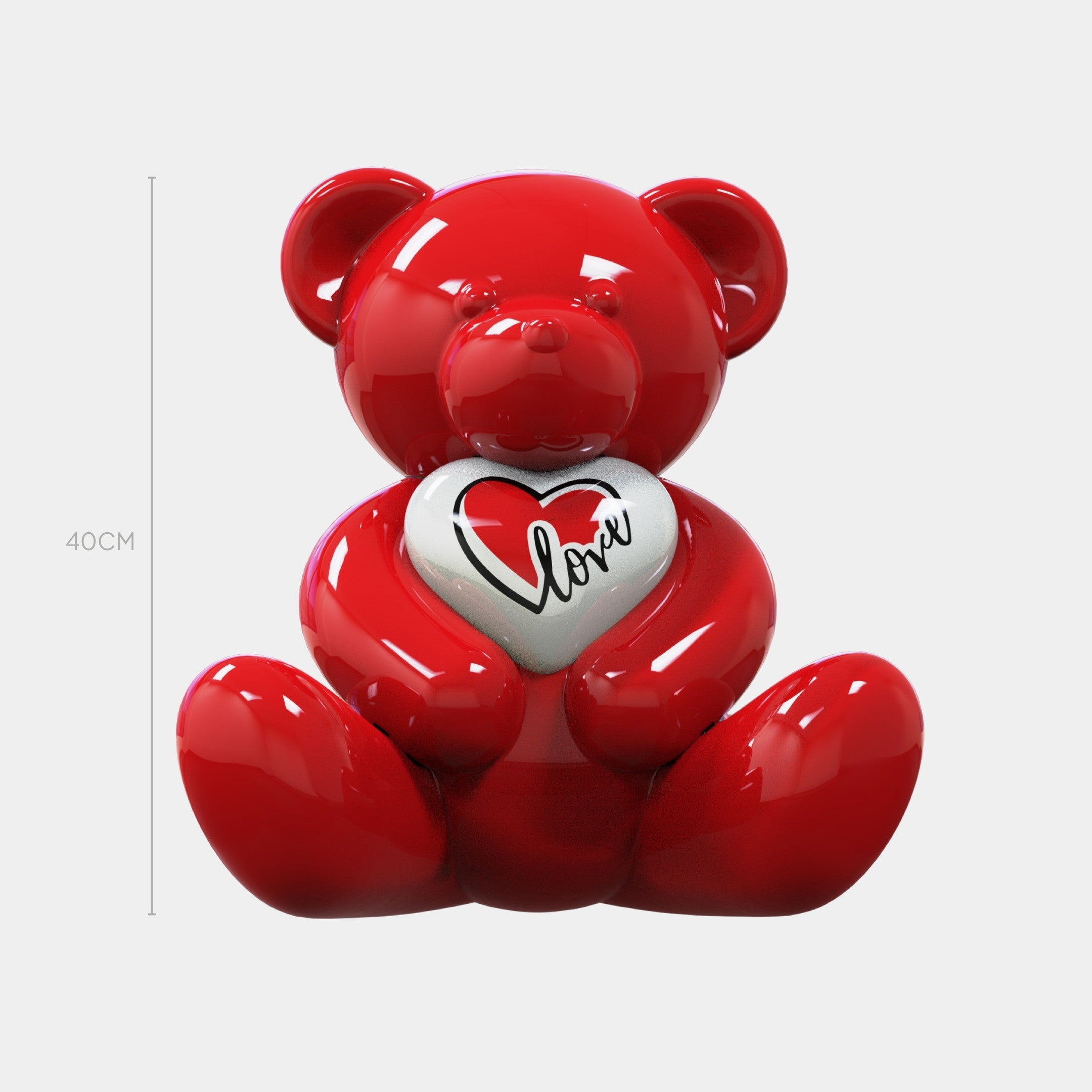 A shiny red Gacko Love Bear Sculpture - 40cm by Giant Sculptures holds a white heart with a red and black heart design and the word "love," shown in contemporary art style against a plain white background.