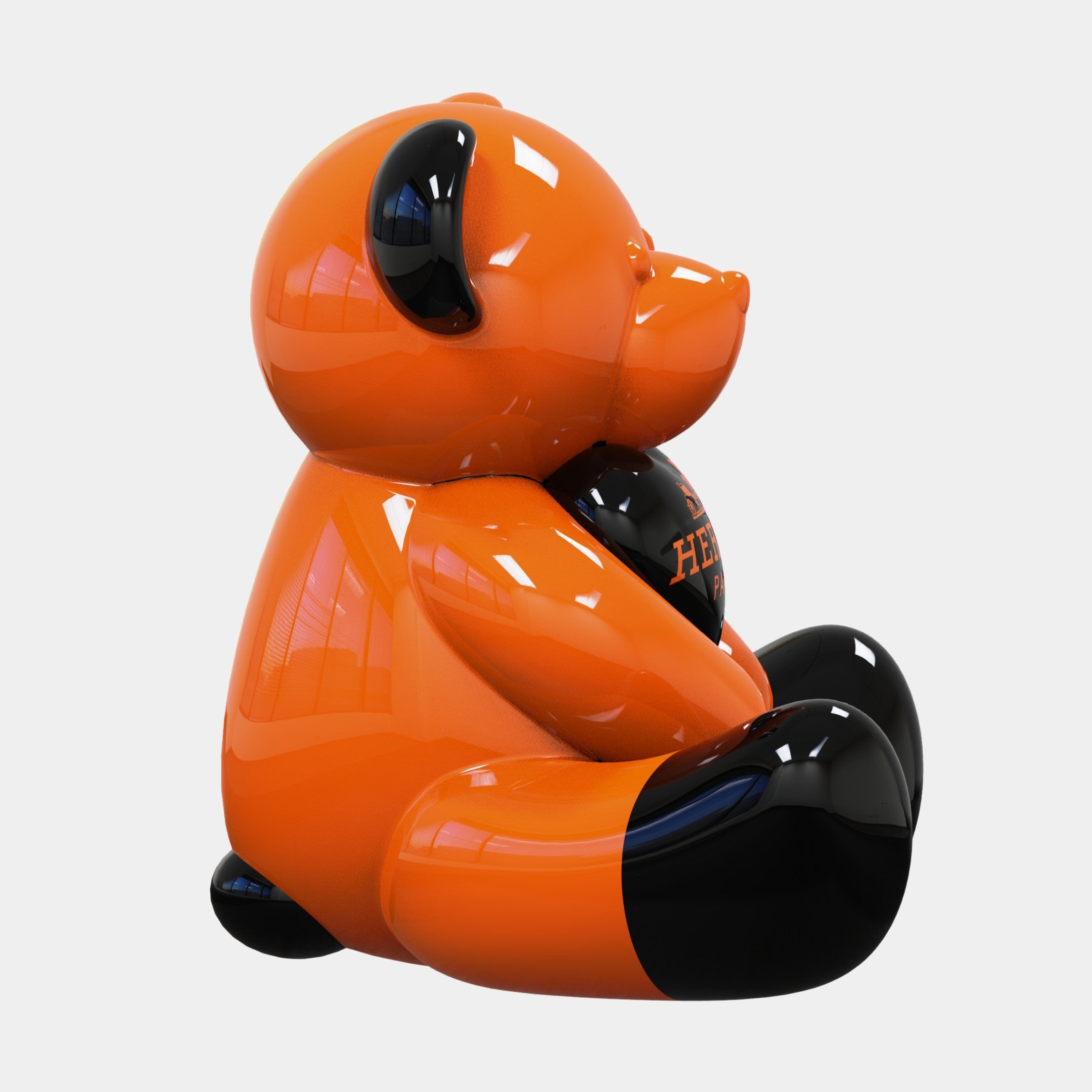 A glossy orange and black bear, the Gacko Hermes Love Bear Sculpture - 160cm by Giant Sculptures, sits upright with HERMÈS printed in orange on its chest. This luxury pop art piece by André Gacko features shiny surfaces and a plain white background.