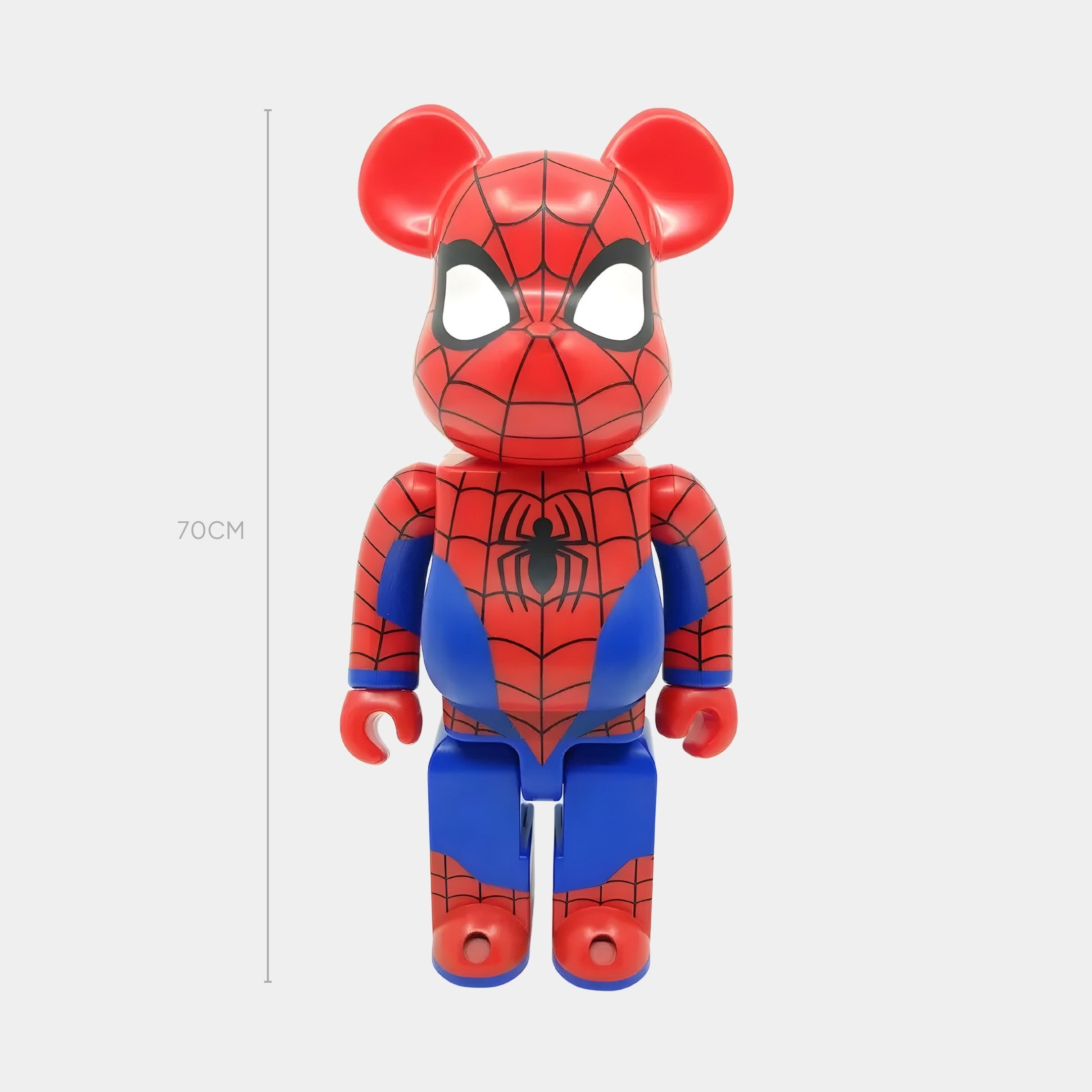 The Giant Sculptures Glossy Spidey Web Bear Sculpture - 70cm features a high-gloss resin bear in a superhero Spider-Man costume, with red and blue tones, web details, and white eye patches, standing upright against a plain background.
