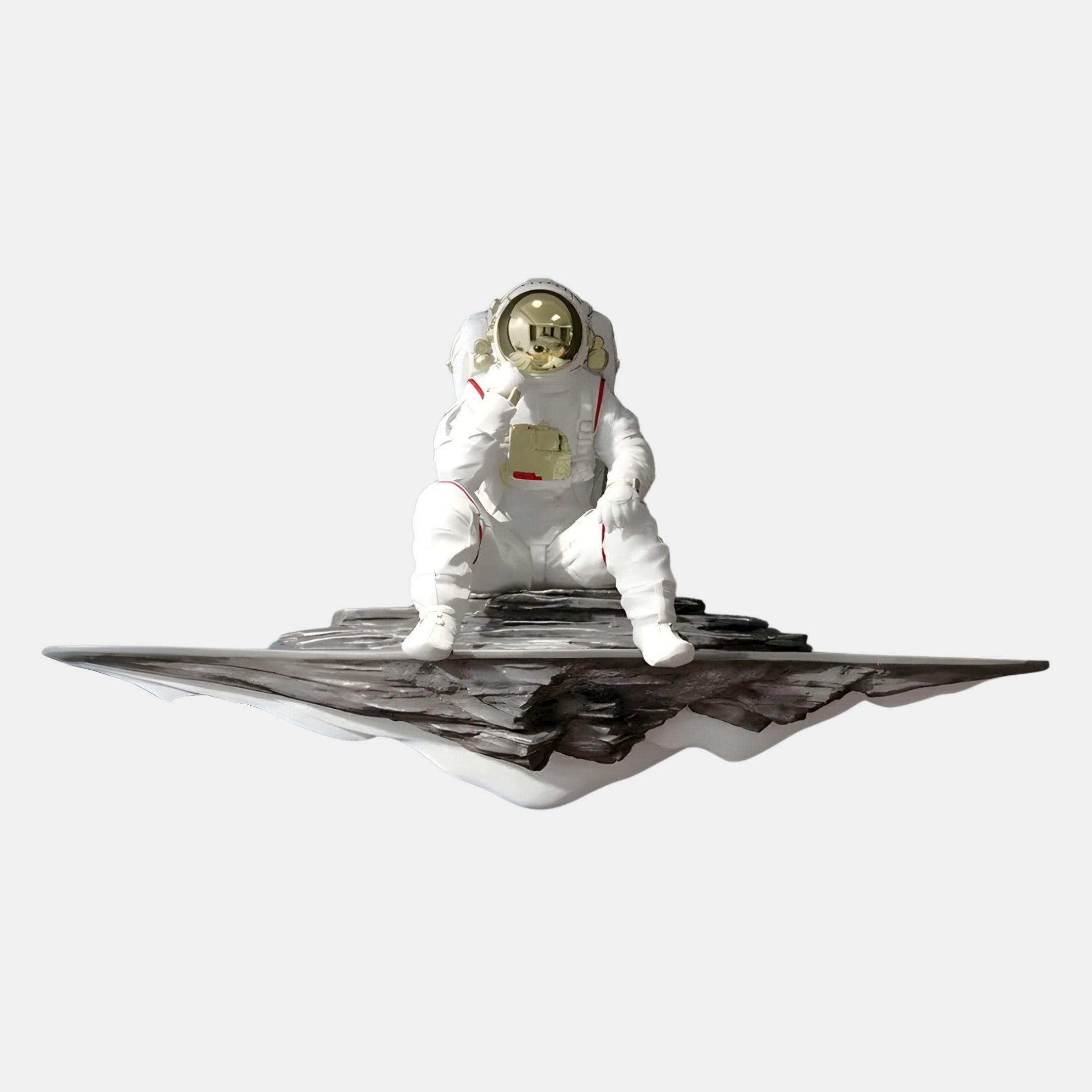 The White Astronaut Thinker On Rocky Shelf 3D Wall Art by Giant Sculptures features a figure in a white suit sitting on a rocky platform, holding its helmet against a light gray background—ideal for modern space décor.