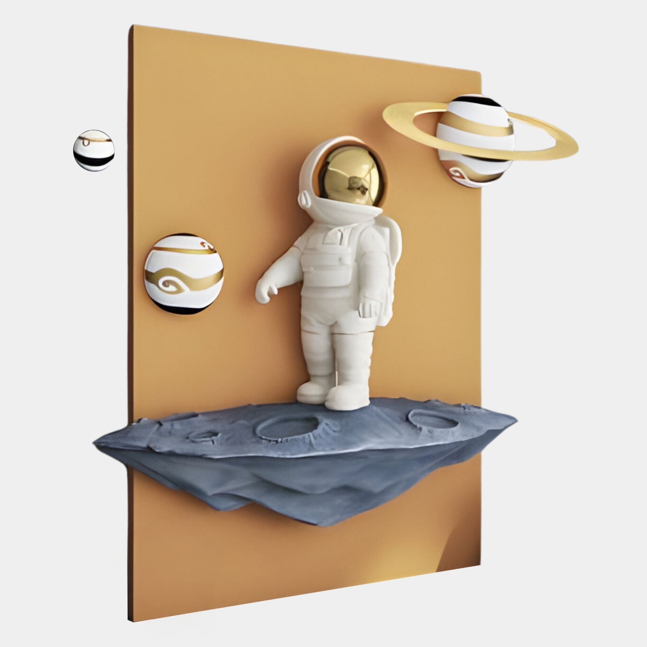 The White 3D Stellar Astronaut Wall Art by Giant Sculptures features an astronaut with a gold helmet on a floating gray asteroid, surrounded by stylized planets and orbs, adding interstellar charm against a brown rectangular backdrop.