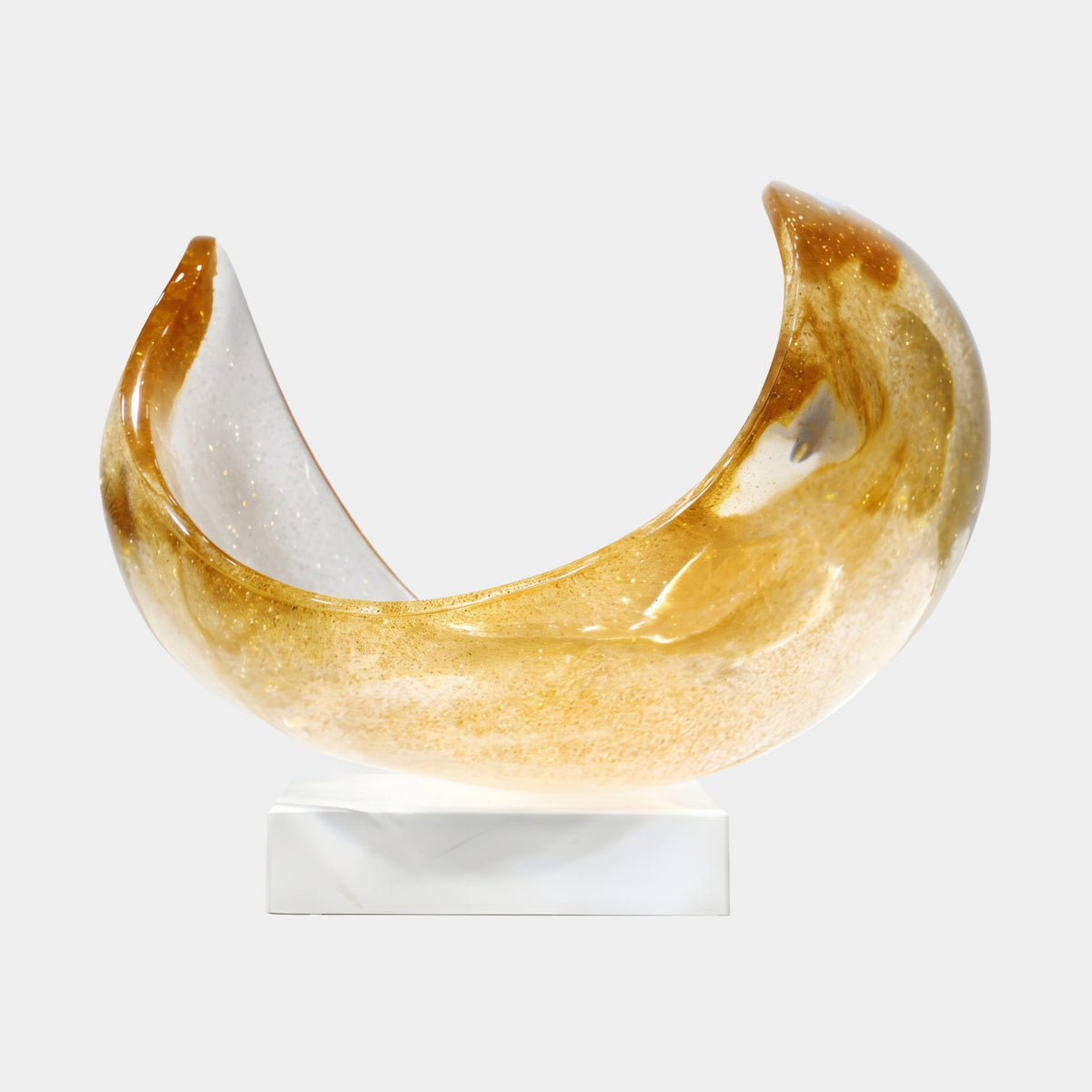 Orange Gold Fleck Crescent Cradle Resin Sculpture (36cm) by Giant Sculptures, honey-amber crescent with orange tips and gold flecks on a white marble base, plain light background.