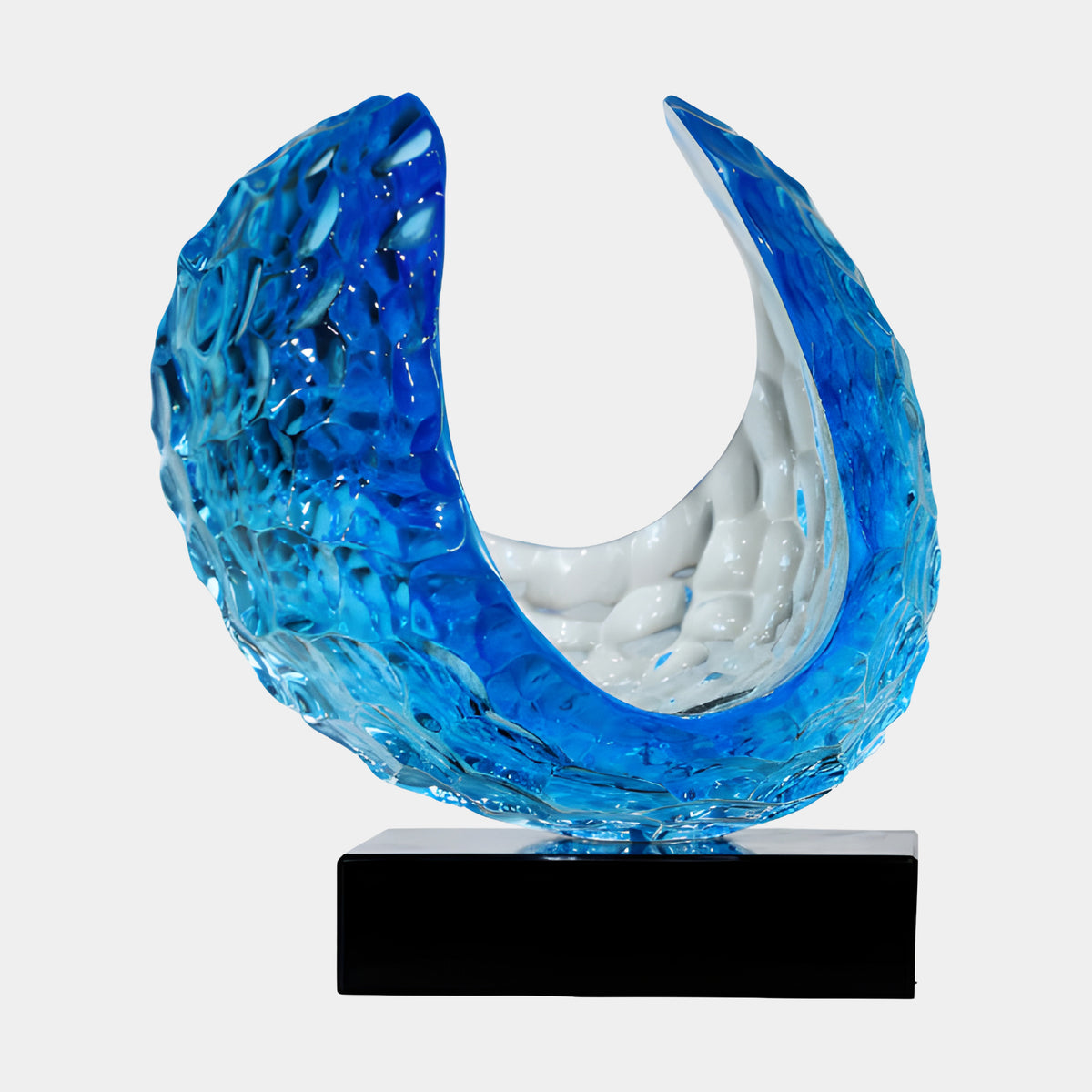 Blue Hammered Crescent Resin Sculpture on Black Base, 38cm, with hammered azure-to-cobalt outer texture and a milky white interior curve, set on a plain white background.