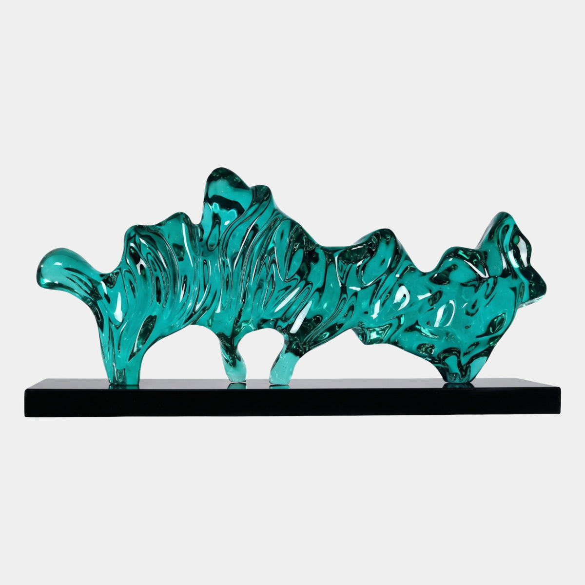 Teal Craggy Ridge Resin Sculpture - 86cm, a jagged ridge-like form with swirling grooves on short legs, set on a black base against a plain light background.