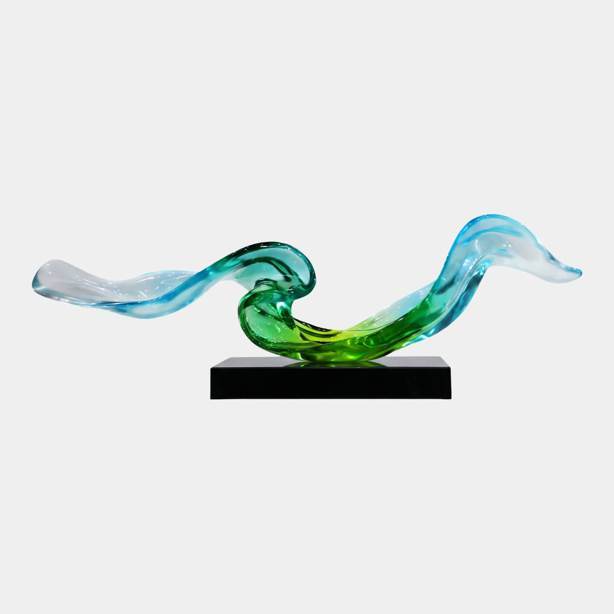 Green & Blue Double Wave Ribbon Resin Sculpture (128cm) with curling S-curves fading from green to blue to clear tips, on a black marble block, plain white background.
