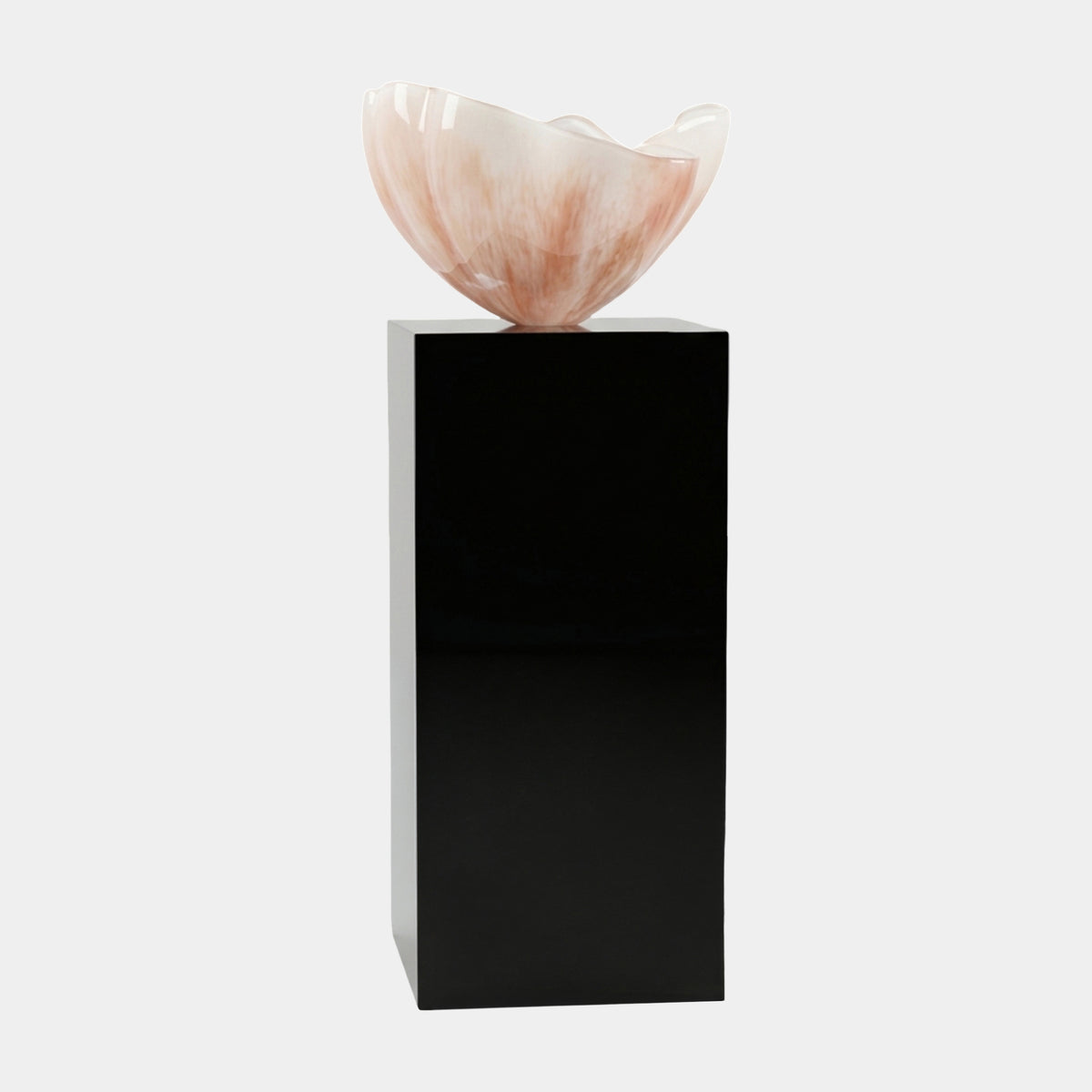 Cream Petal Cup on a Marble Column Resin Sculpture, 125cm, cream and peach wavy petal-shaped cup atop a tall black square marble column, plain white background.