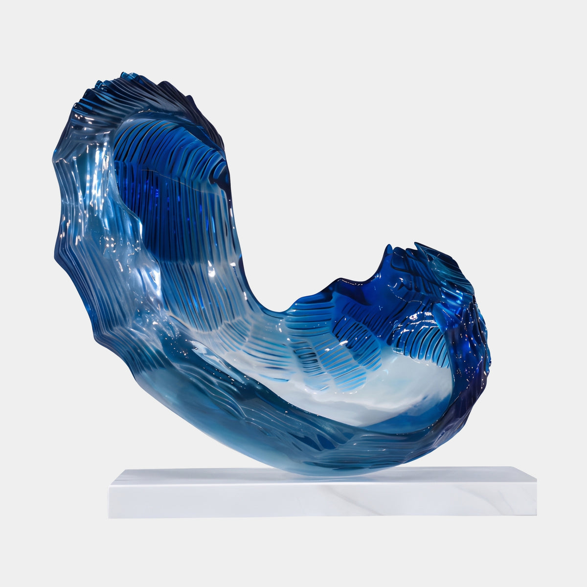Cobalt Combed Torn Cradle Resin Sculpture - 66cm, a curved cobalt blue resin wave form with combed ridges and torn edges, on a white slab base against a plain background.