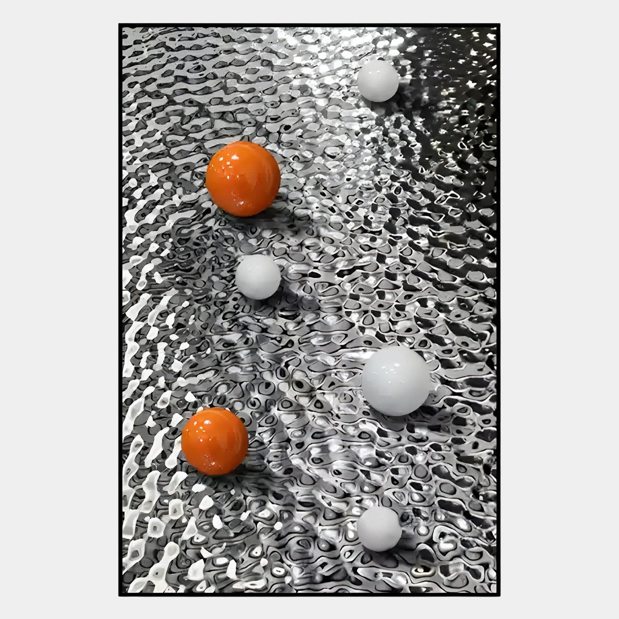 Two orange and four white spheres rest on a rippled, reflective metallic surface in this striking Luminosa Orange & White Orb Textured Metal Wall Art by Giant Sculptures, perfect for contemporary interiors and those seeking abstract decor.