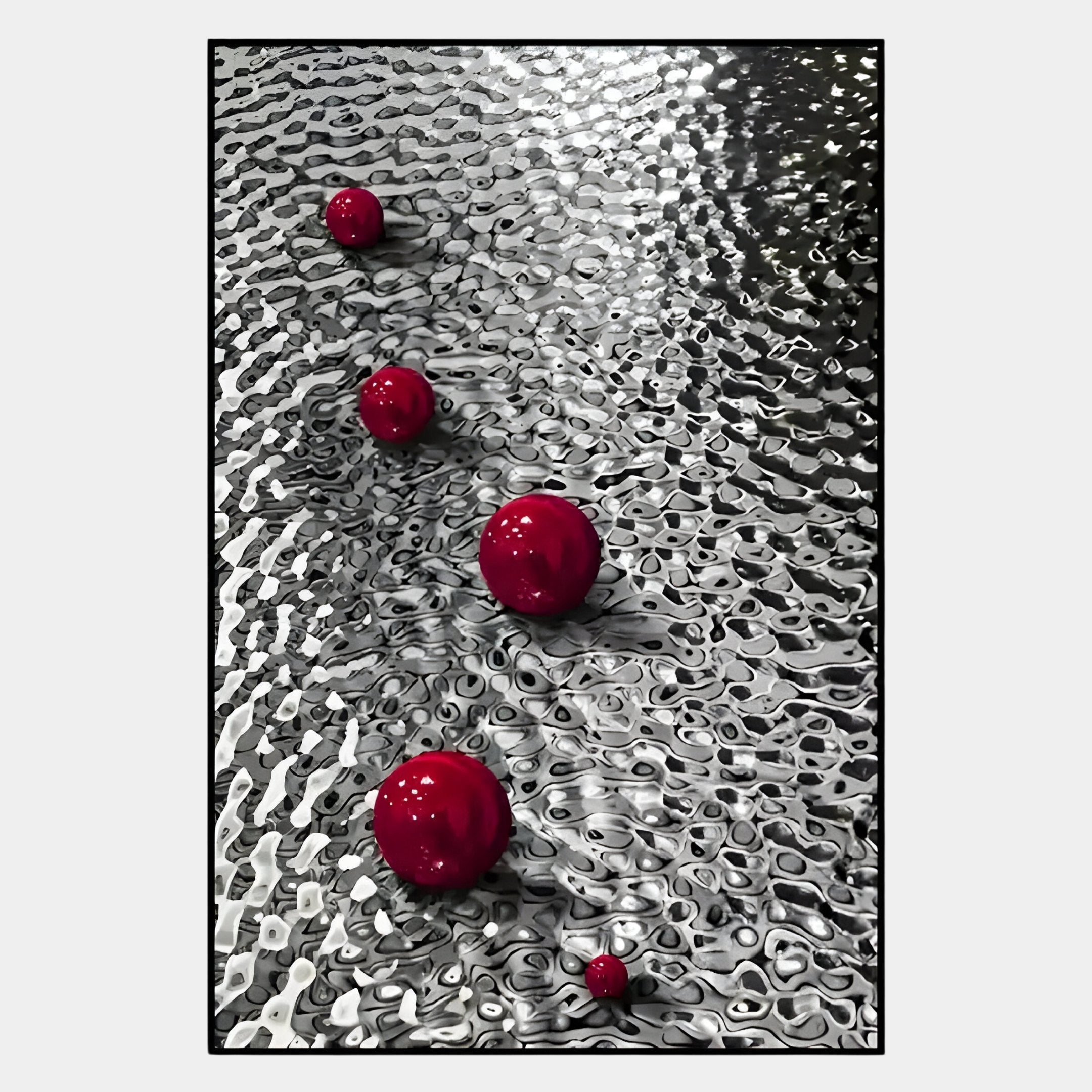 The Luminosa Red Orb Textured Metal Wall Art by Giant Sculptures features four red spheres on a rippled stainless steel surface, creating dynamic reflections and shadows—an eye-catching piece perfect for bold, modern decor.