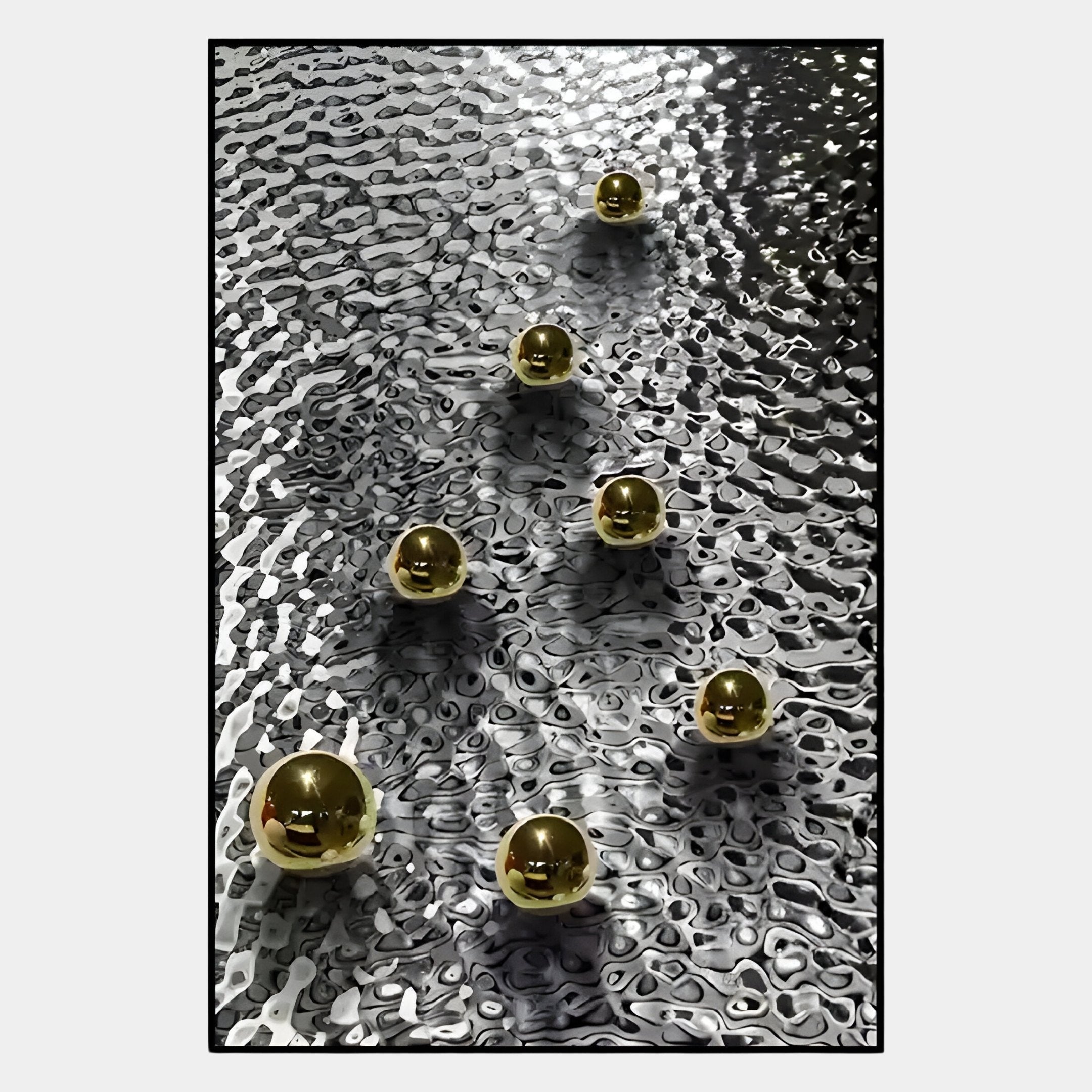Six shiny gold spheres are arranged diagonally on a textured, wavy black-and-white surface in the Luminosa Gold Orb Textured Metal Wall Art by Giant Sculptures, creating a striking, reflective effect perfect for contemporary spaces.