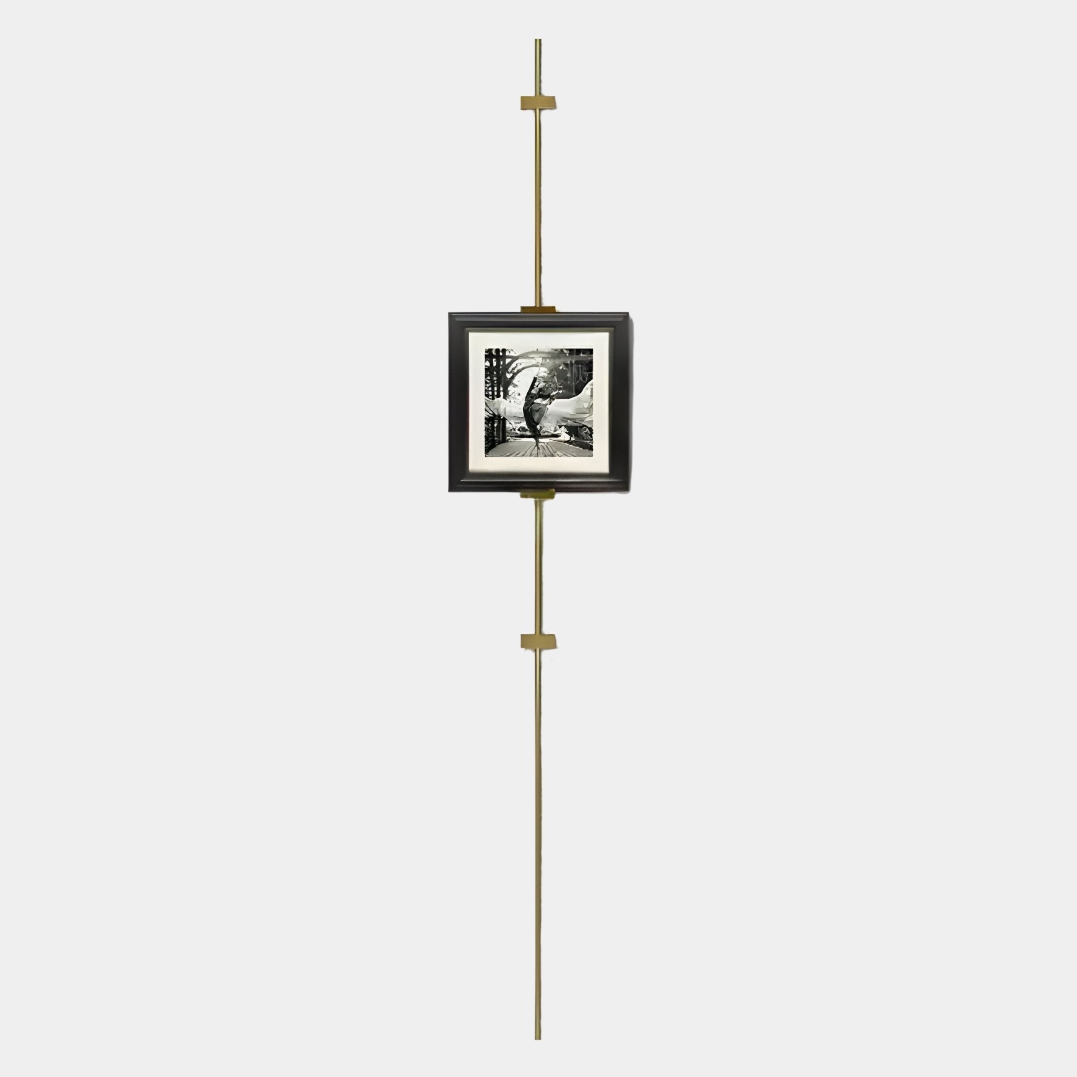 The Giant Sculptures Ecliptica Graceful Dancer Abstract Gold Frame Wall Art hangs on a slim brass picture rail against a white wall, blending minimalist style with secure, centered display.