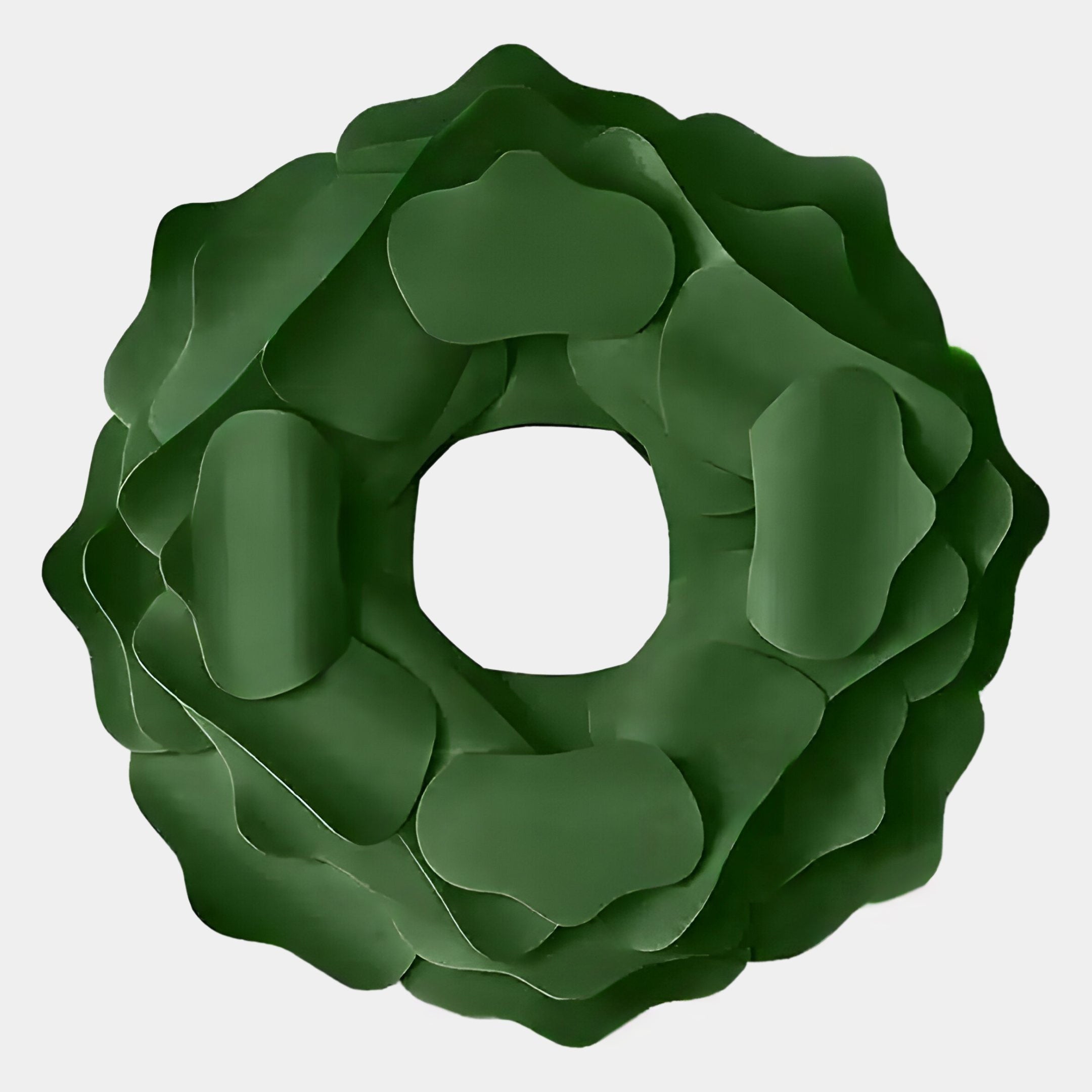 The Sculptura Mirror Forest Green Floral Round Metal Wall Art by Giant Sculptures features layered, petal-like shapes and a hollow center, creating an abstract green wreath or flower design against a light background.