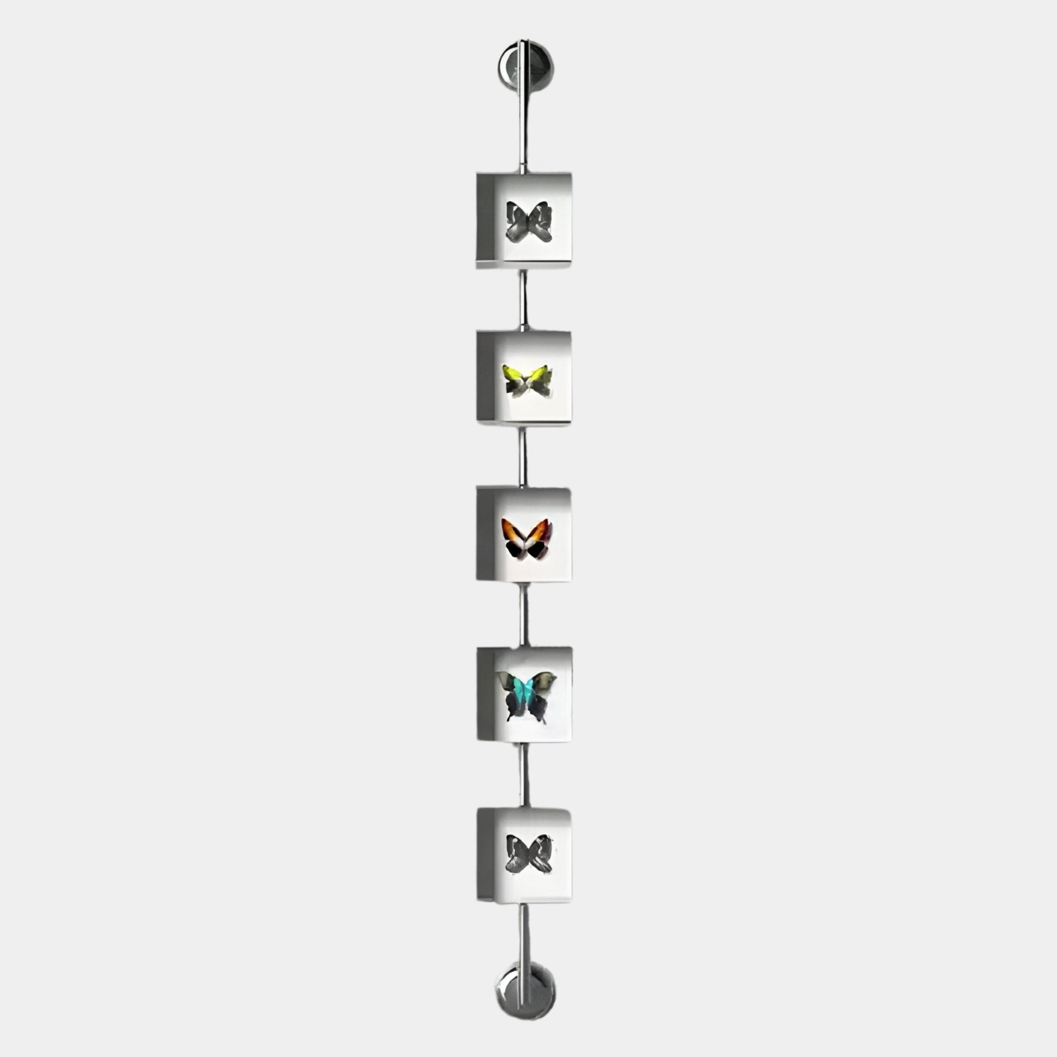 The Papilio Butterfly Vertical Clear Modern 3D Wall Art by Giant Sculptures showcases five butterfly specimens in square frames connected by a metal rod, creating striking, nature-inspired decor for any modern space.