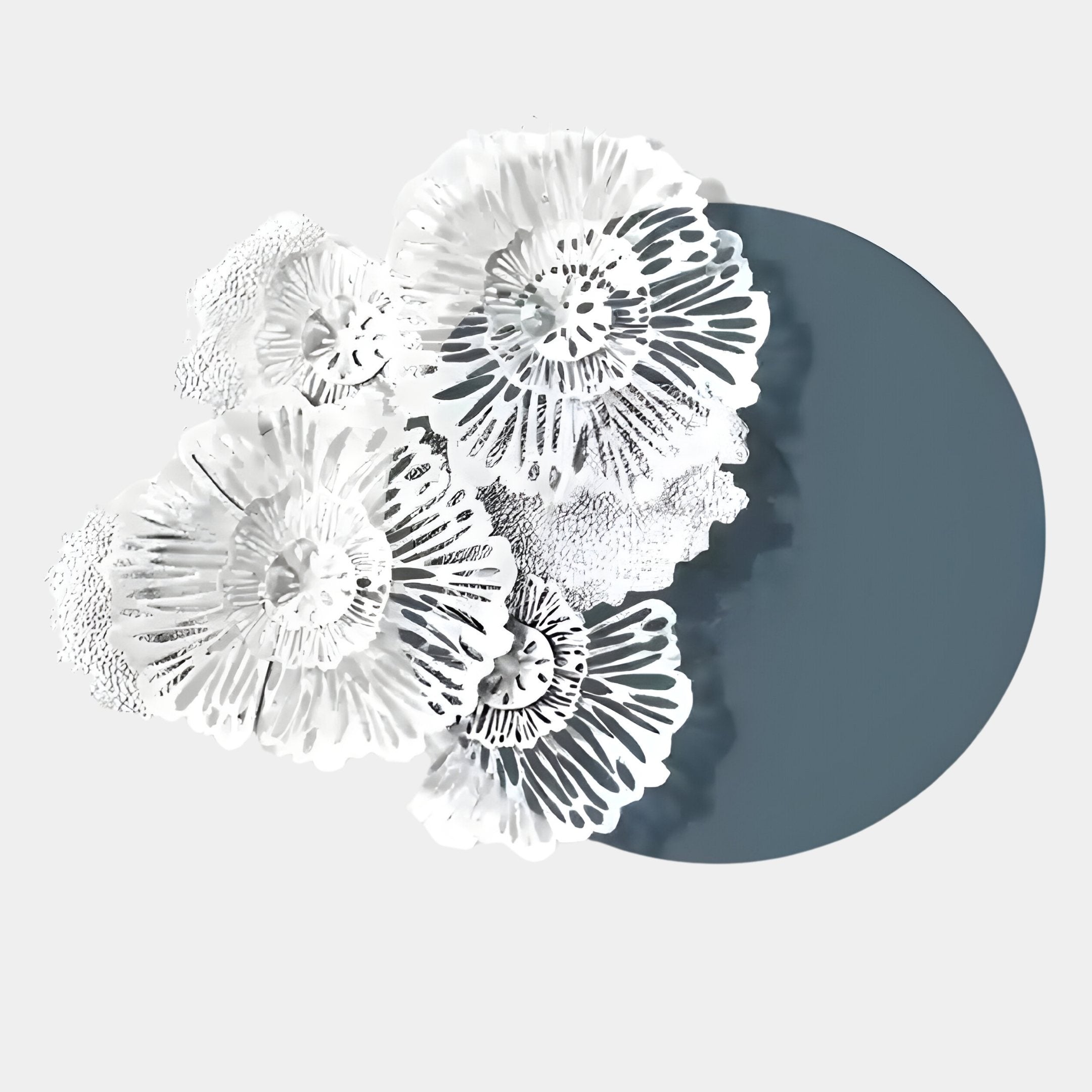 The Fleur Halo Grey Round White Metal Floral Decorative Wall Art by Giant Sculptures features delicate, overlapping flower-like shapes on a teal-gray circle, adding modern abstract flair to your space.