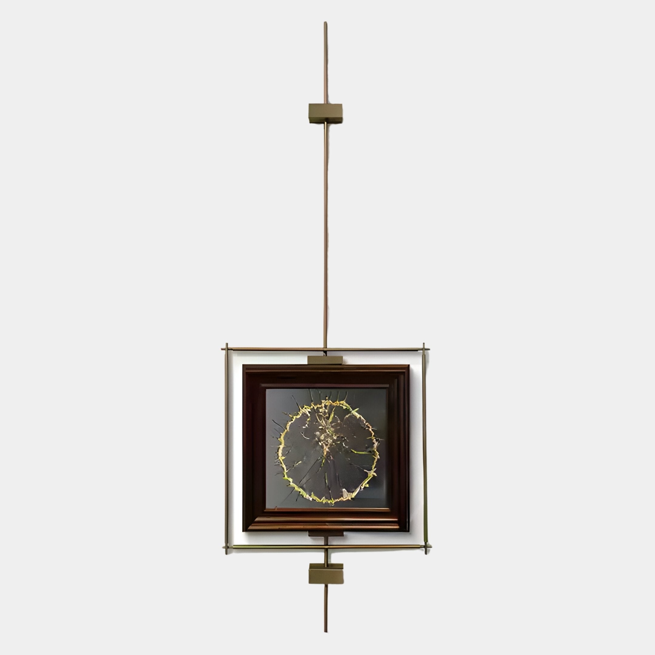 The Ethereal Frames Golden Tree Classic Suspended Wall Art by Giant Sculptures features a circular gold tree pattern on a dark background, suspended vertically by a metal rod with geometric brass fittings—a contemporary statement piece.