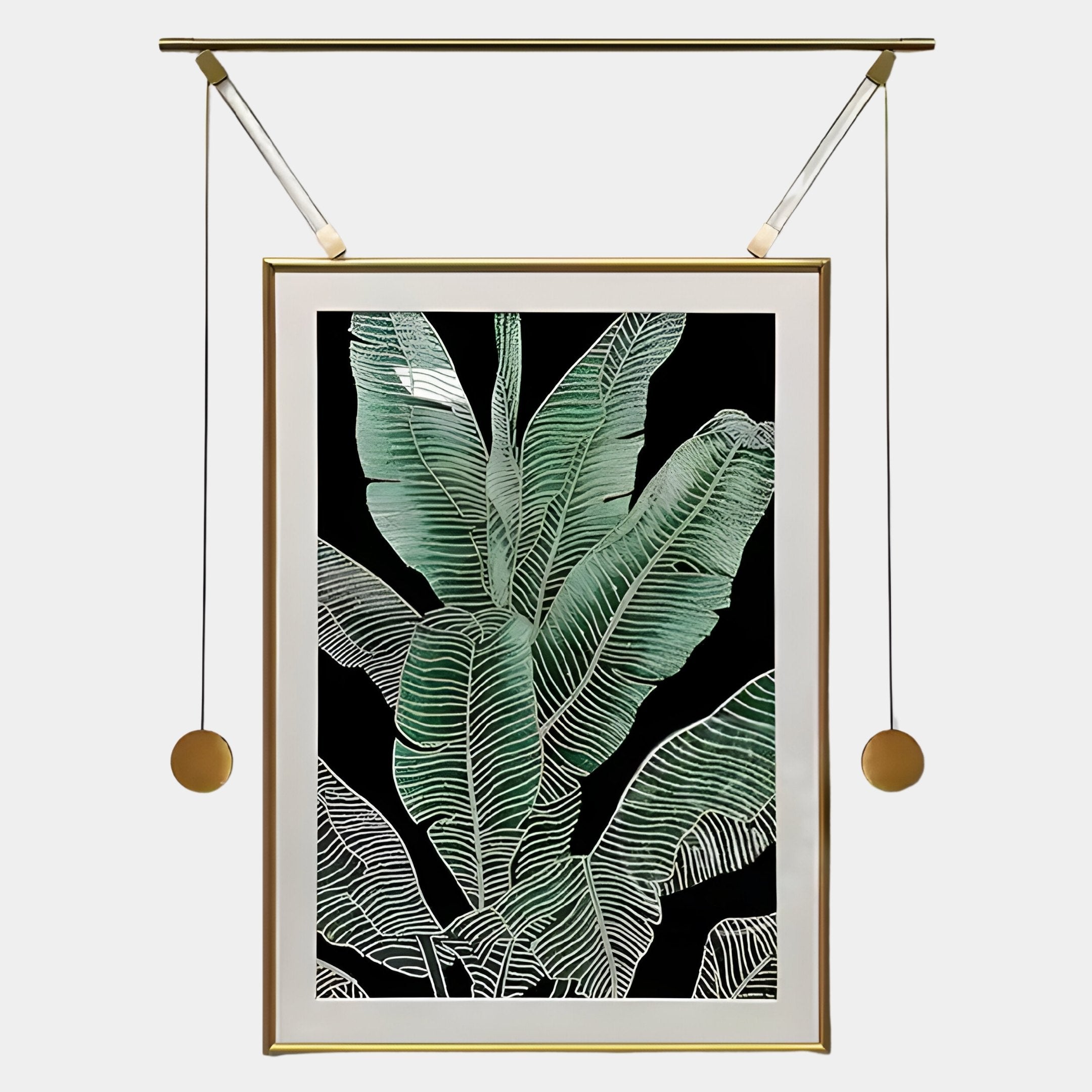 The Glacia Green Botanical Crystal Hanging Framed Wall Art by Giant Sculptures features vivid banana leaves with white veins on black, suspended from a gold rod with weighted cords—a bold, modern botanical piece.