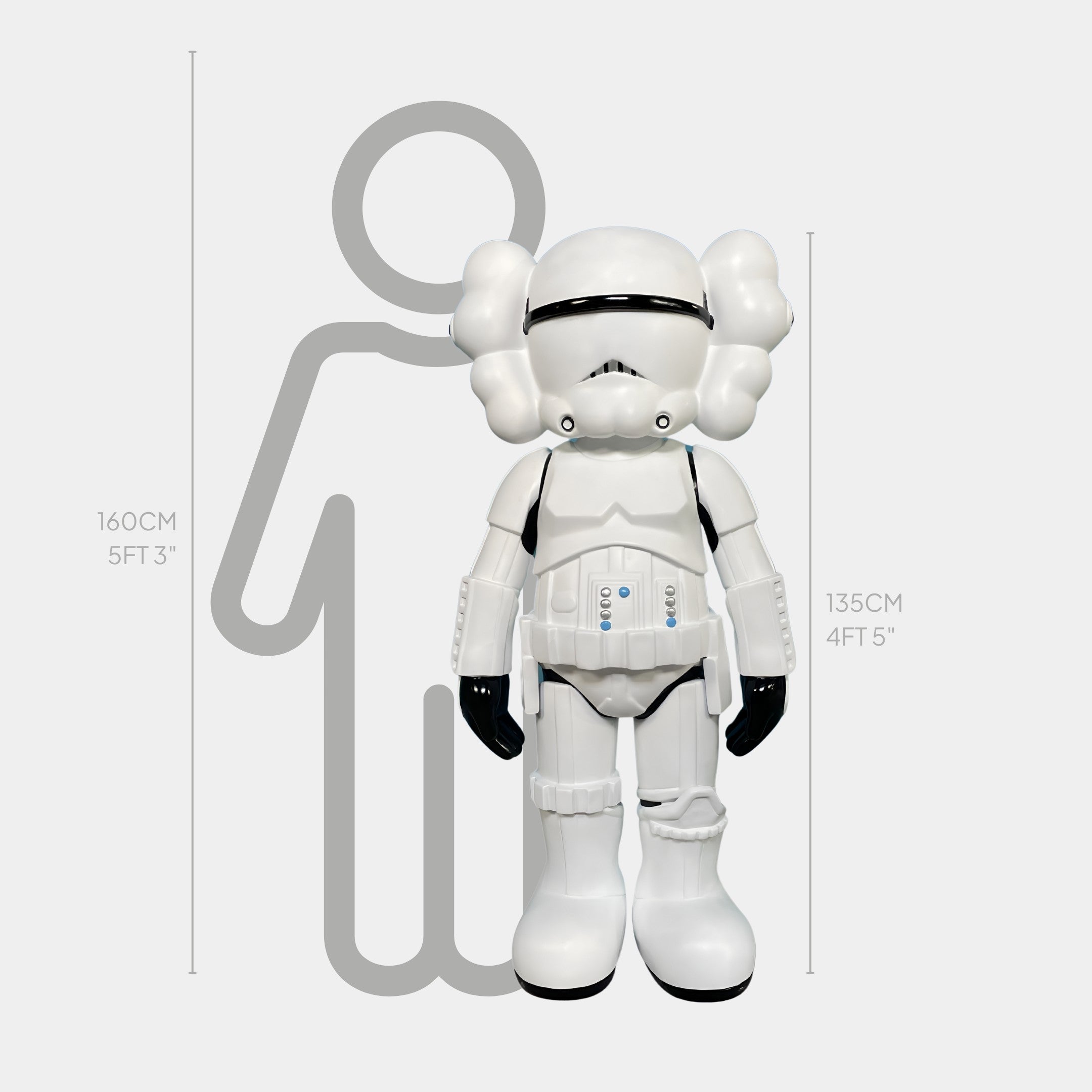 A white cartoon-style figure in stormtrooper gear, the Giant Sculptures Black & White Iconify Enforcer Sculpture (135cm), stands before a gray 160cm silhouette, showcasing its striking modern design.