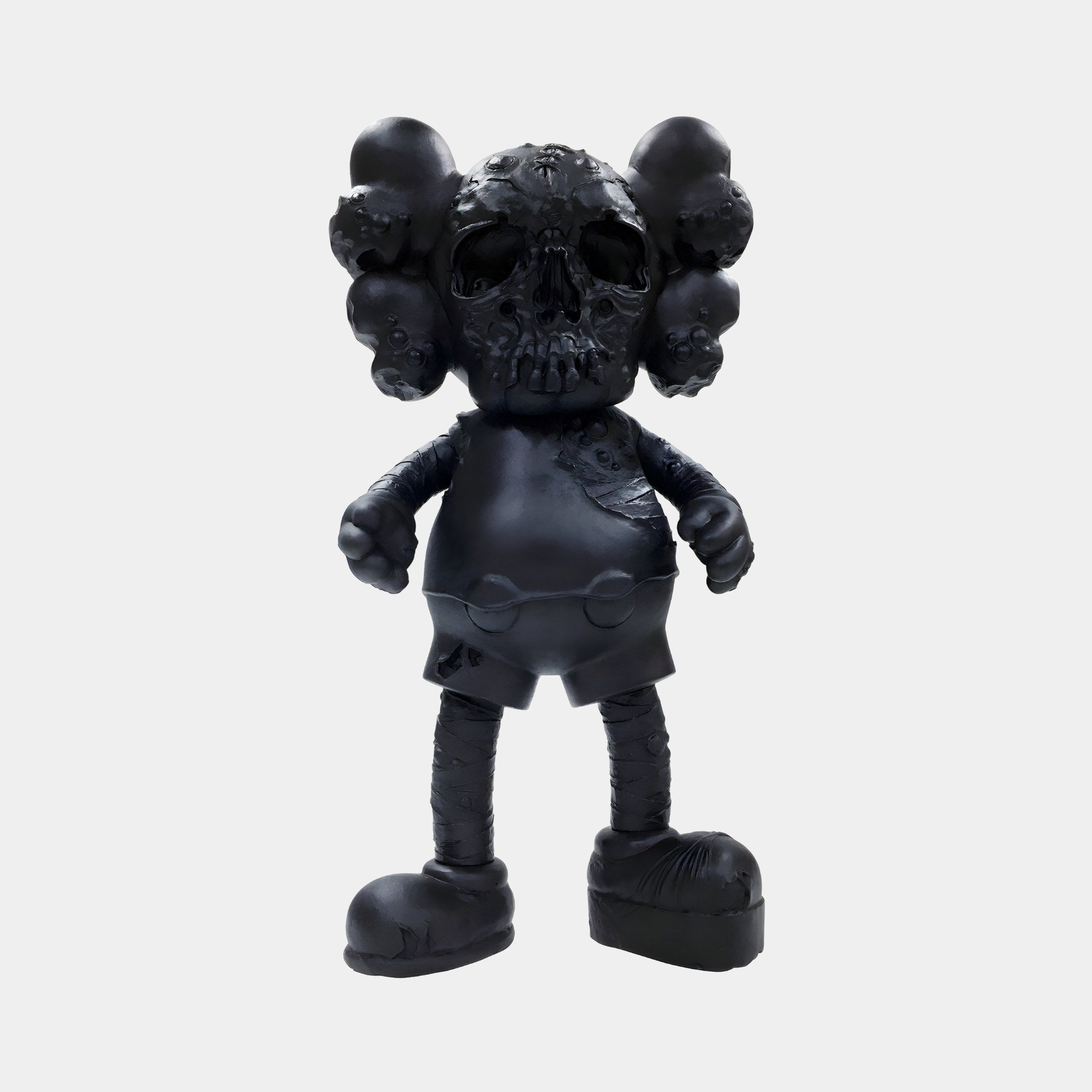 The Giant Sculptures Midnight Black Iconify Scar Figure - 20cm is a resin sculpture with round ears, resembling a stylized mouse. It features a skull-like face, bumpy texture, short legs and arms, large feet, and visible stitching details enhancing its unique charm.