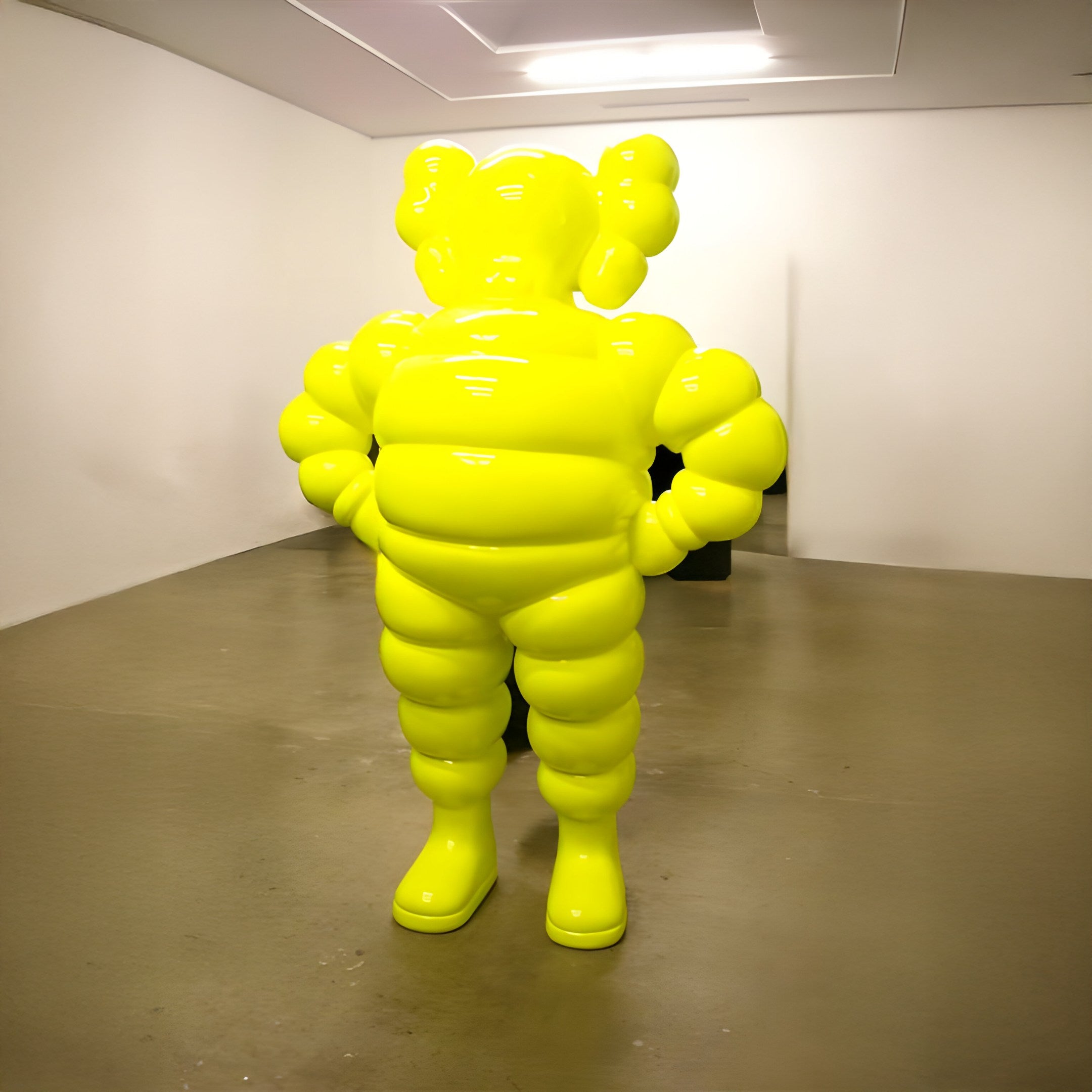 The Giant Sculptures Citrus Yellow Iconify Rollo Warrior Sculpture - 80cm, with its vibrant modern design and abstract balloon-like shapes, enlivens a minimalist gallery rooms expressive interior of polished concrete floors and white walls.