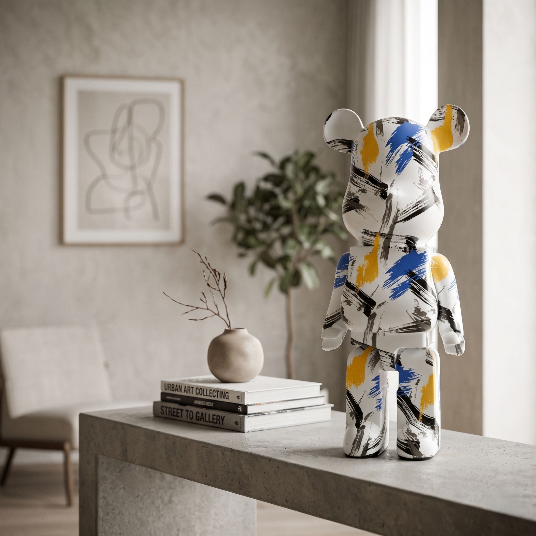 Indigo Infinity Bear Sculpture - 50cm, resin bear figure with blue, black, and yellow brush-stroke design on a white base, shown on a console table in a neutral living room setting.