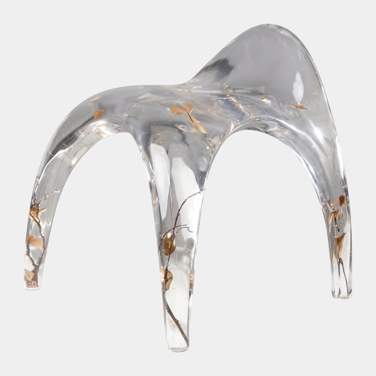 Clear & Gold Arched Resin Stool - 60cm with a saddle-shaped seat and splayed, tapering legs embedding dark twigs and gold leaves, shown on a plain white background.