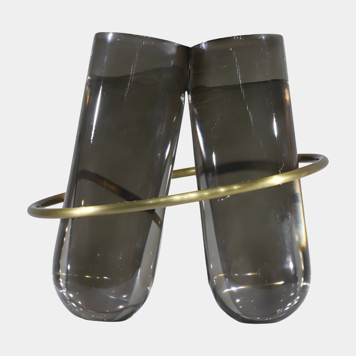Grey Leaning Cylinder Gold Ring Resin Sculpture - 45cm, two smoked grey translucent resin cylinders leaning together, encircled by a gold metal ring, on a plain white background.