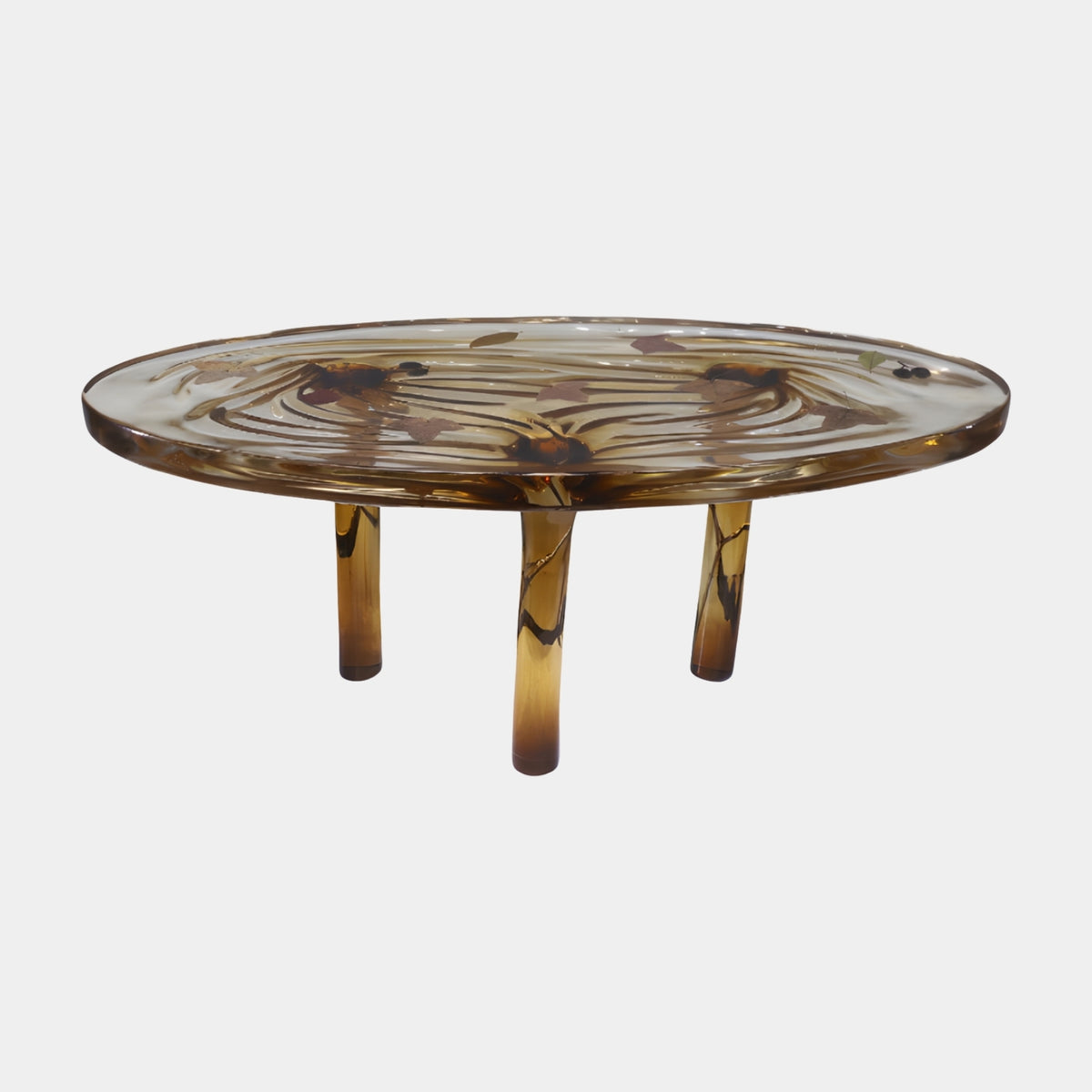 Amber Set Leaf Oval Cast Resin Low Table, 111cm, with clear amber-brown resin top holding pressed leaves, on three cylindrical legs, shown on a plain white background.