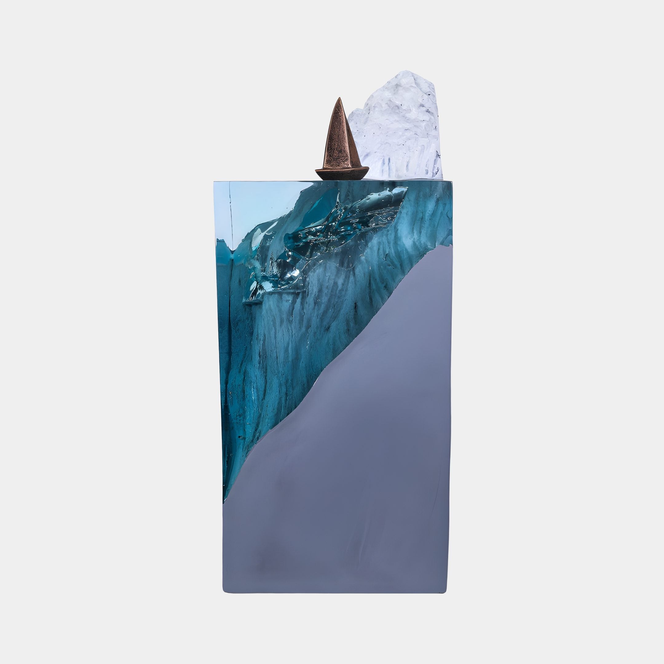 Blue resin waterfall column sculpture by Giant Sculptures, 91cm, with a bronze boat and white peak atop a grey base, shown on a plain background.