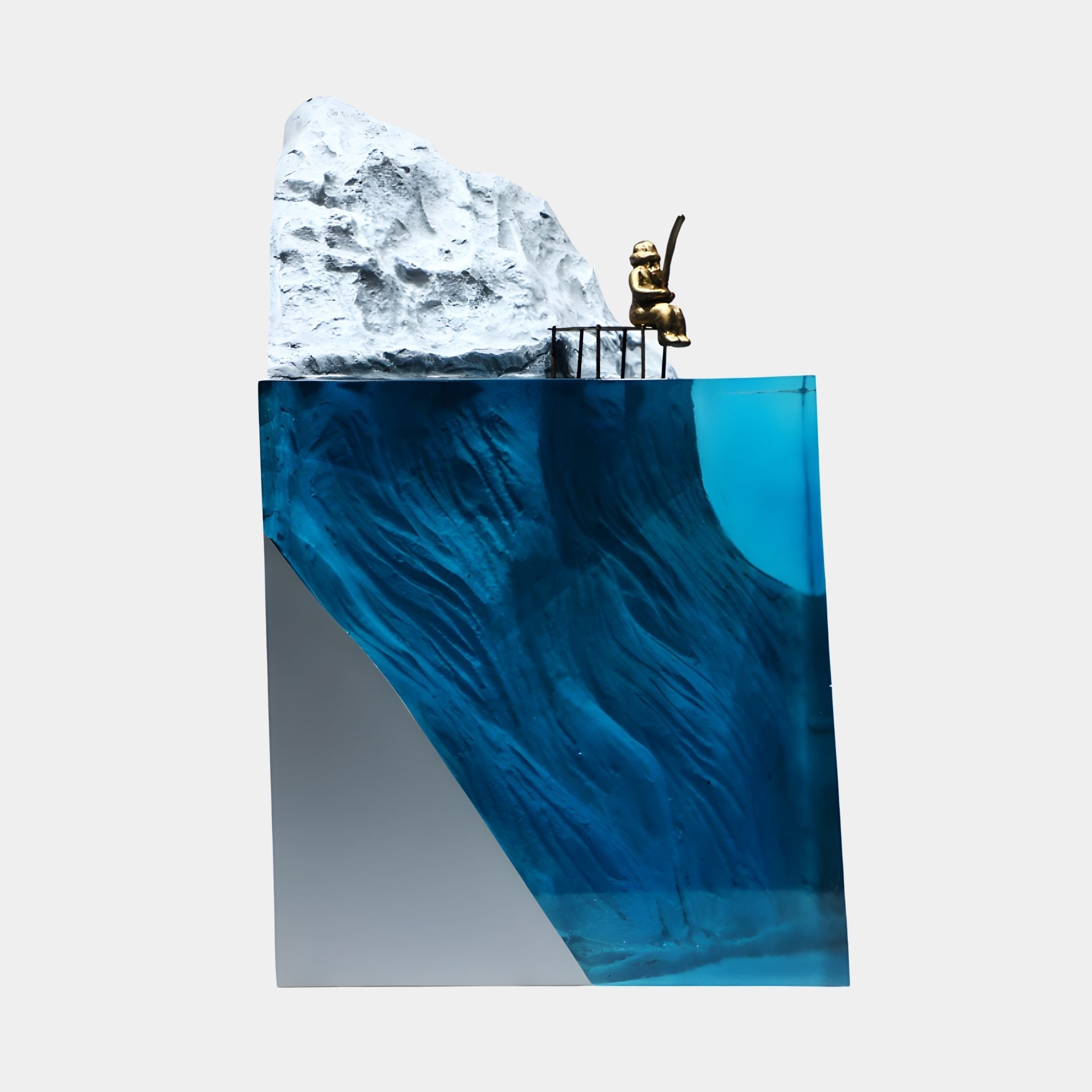 Deep Blue Glacial Mountain & Gold Fisherman Sculpture 50cm by Giant Sculptures, with a gold figure on a white peak above a blue resin sea block.